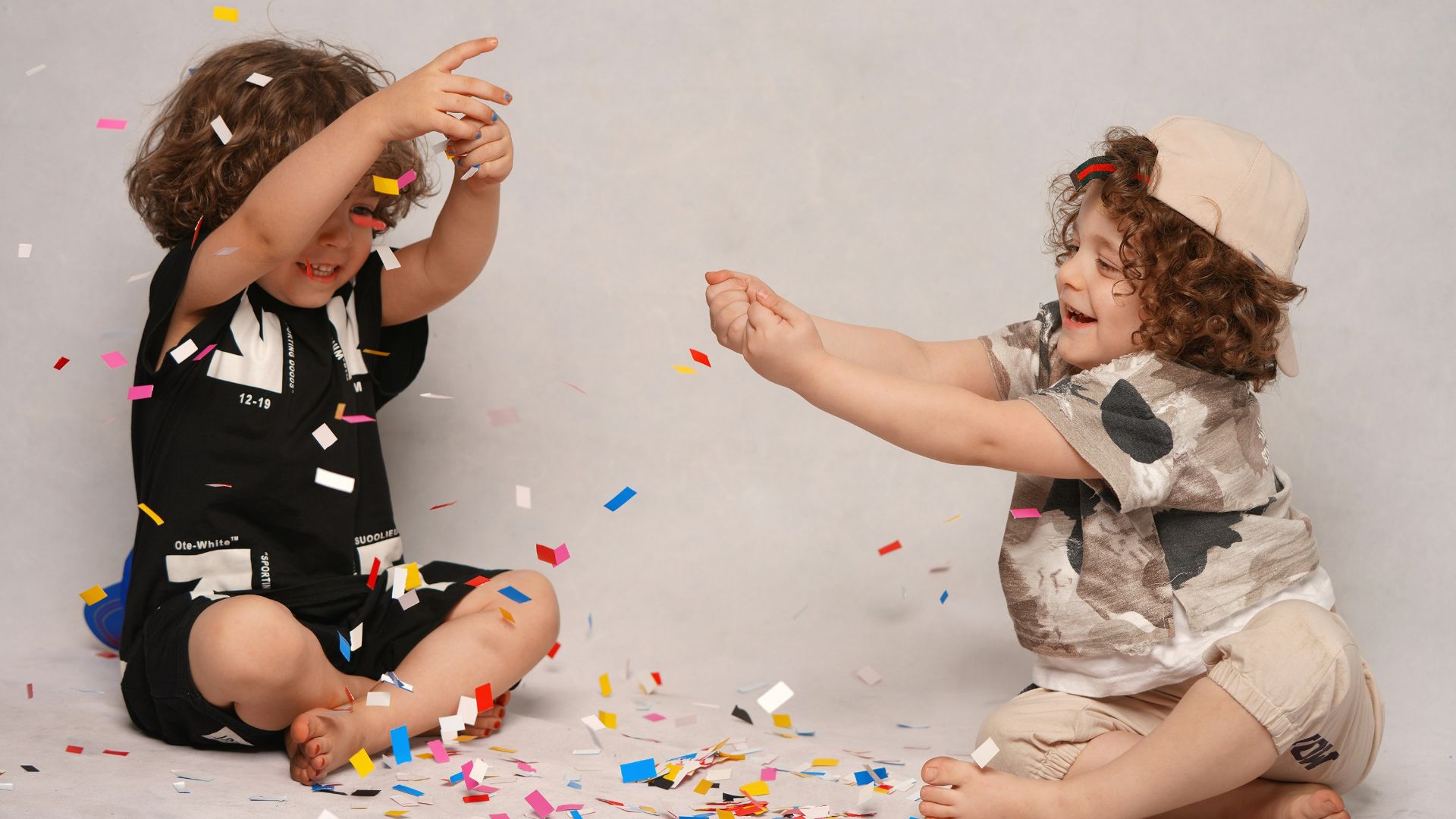 girl in black and white shirt playing with girl in white shirt