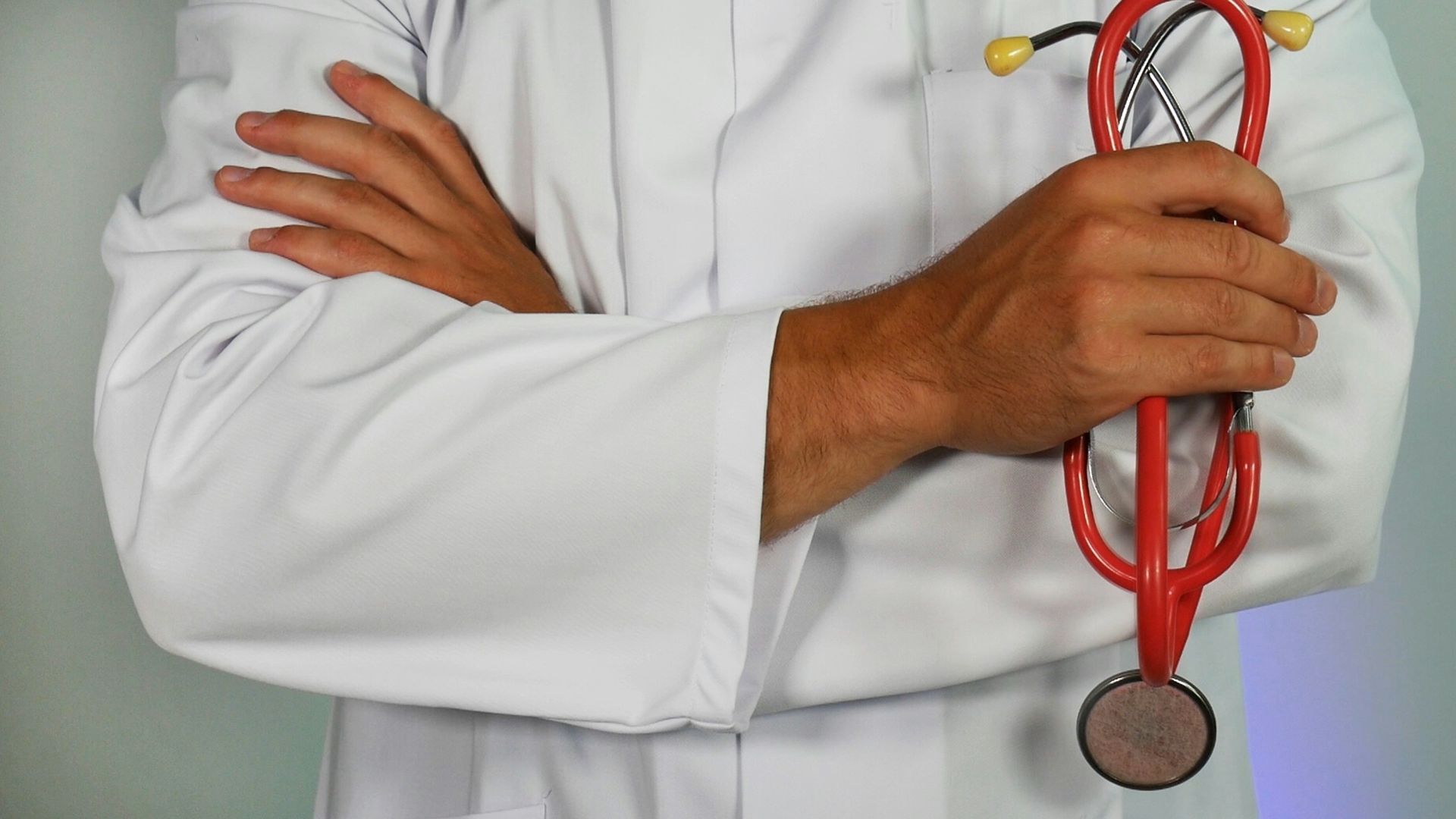 doctor holding red stethoscope