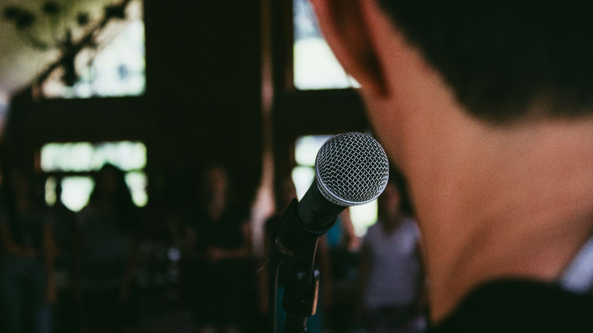man standing in front of microphone