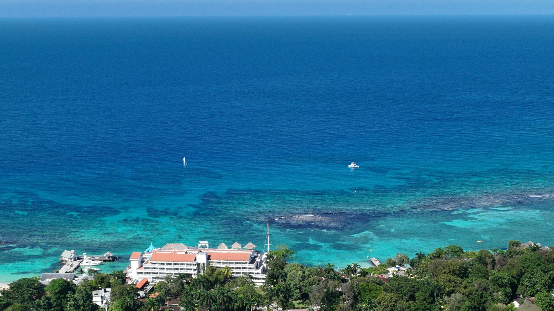 an aerial view of a town and the ocean