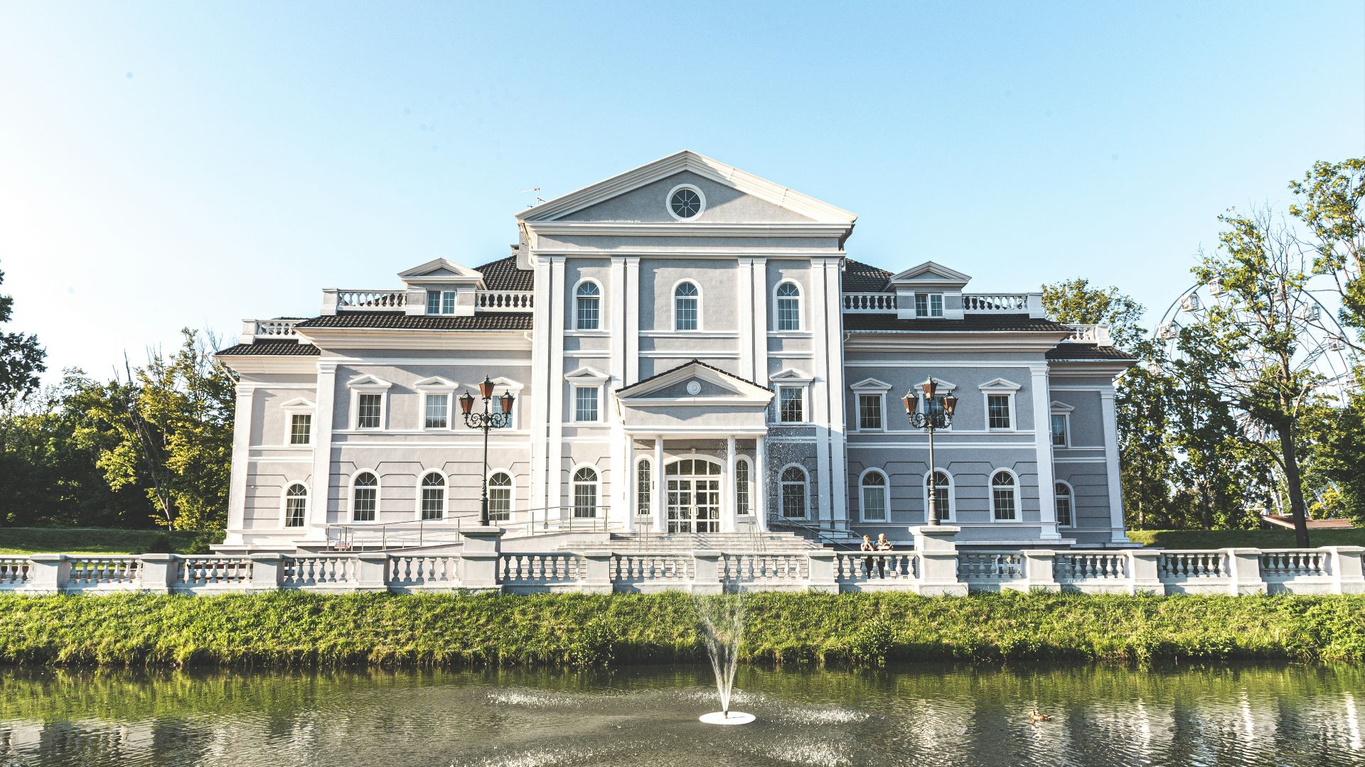 trees beside white concrete building