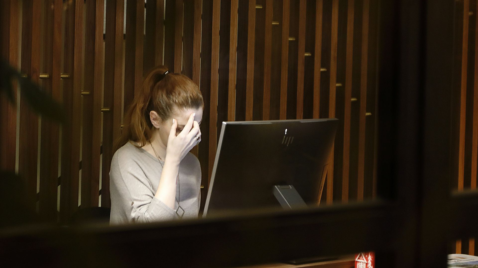 a woman sitting in front of a laptop computer