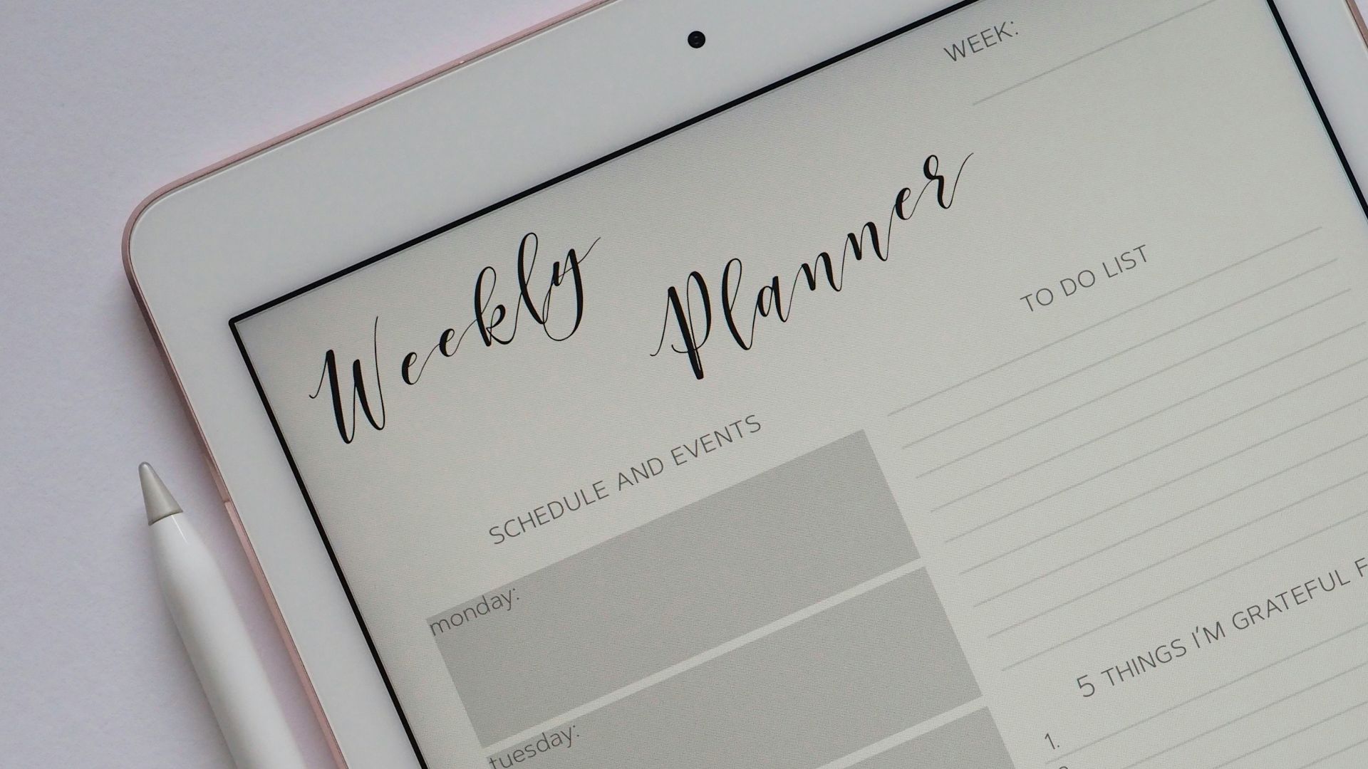 flat lay photography of turned-on silver iPad beside Apple Pencil