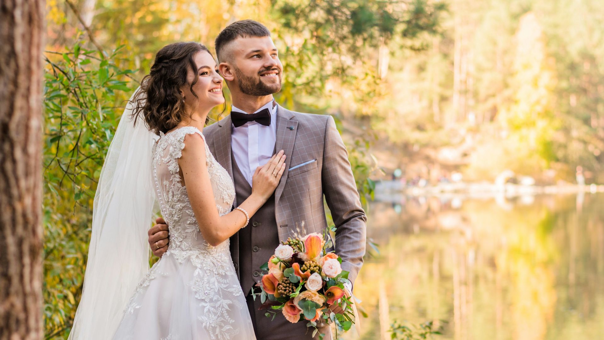 man in gray suit and woman in white wedding dress