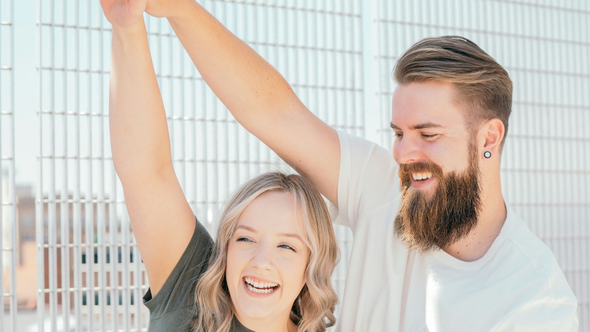 man in white crew neck t-shirt standing beside woman in gray t-shirt