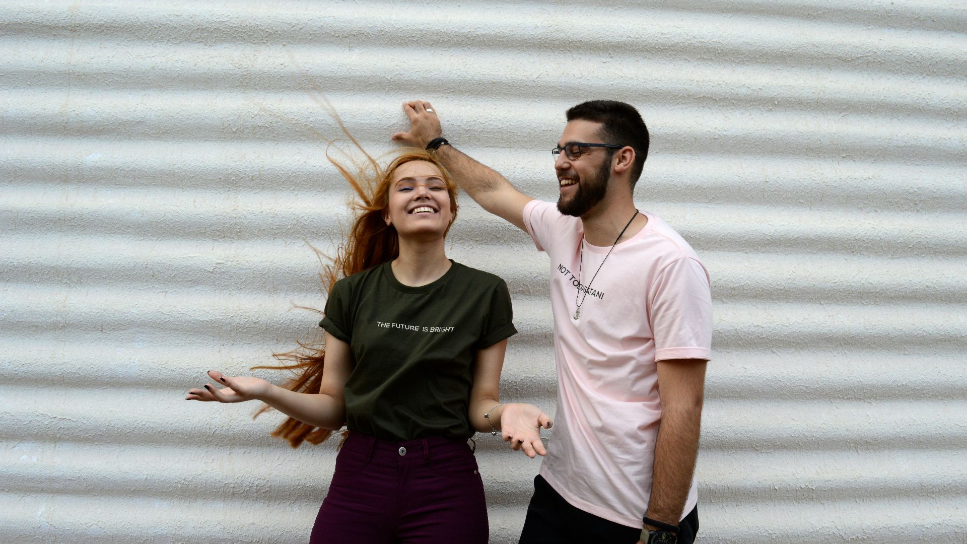 man and woman standing while chatting