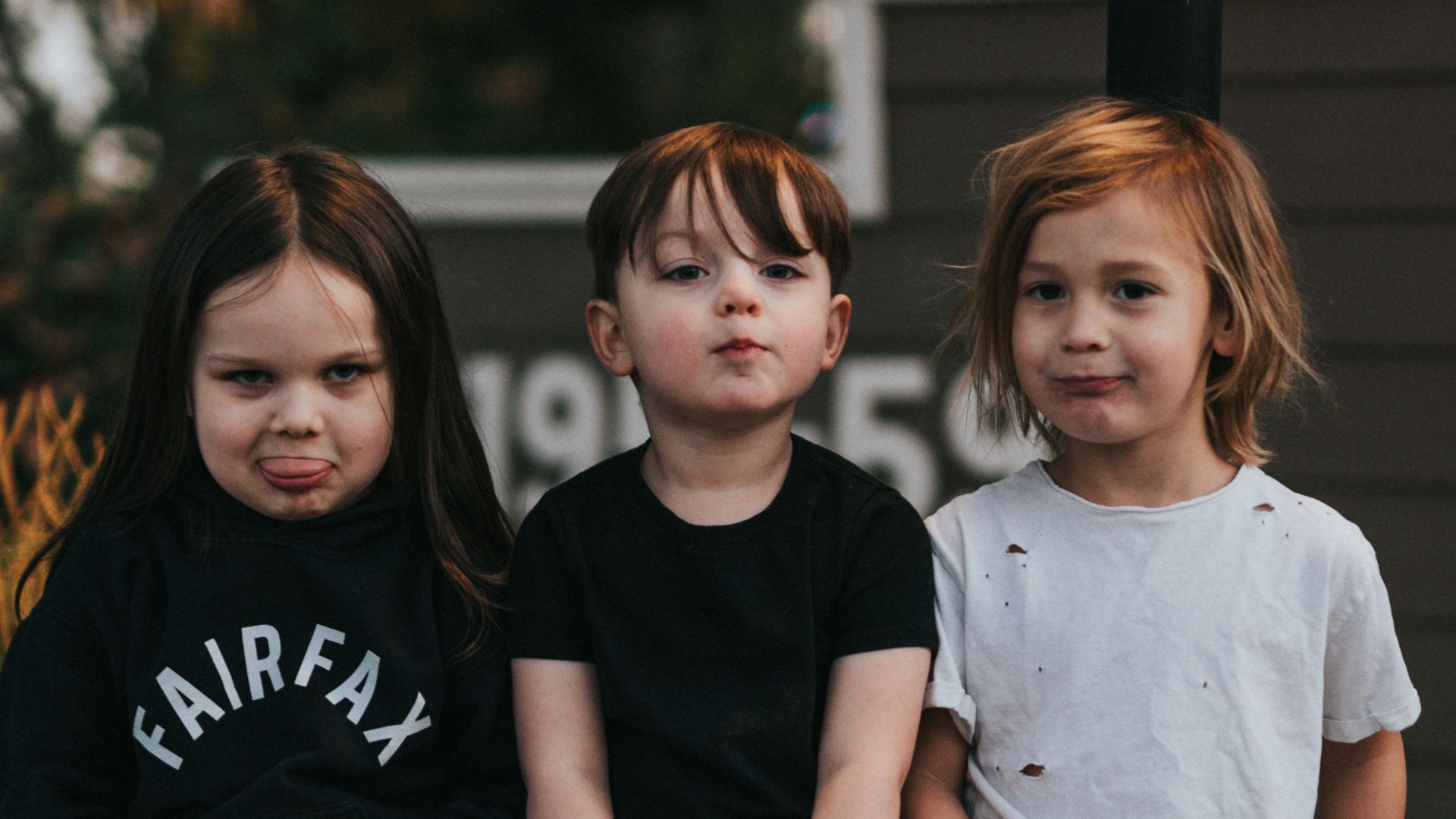 3 boys sitting on concrete stairs