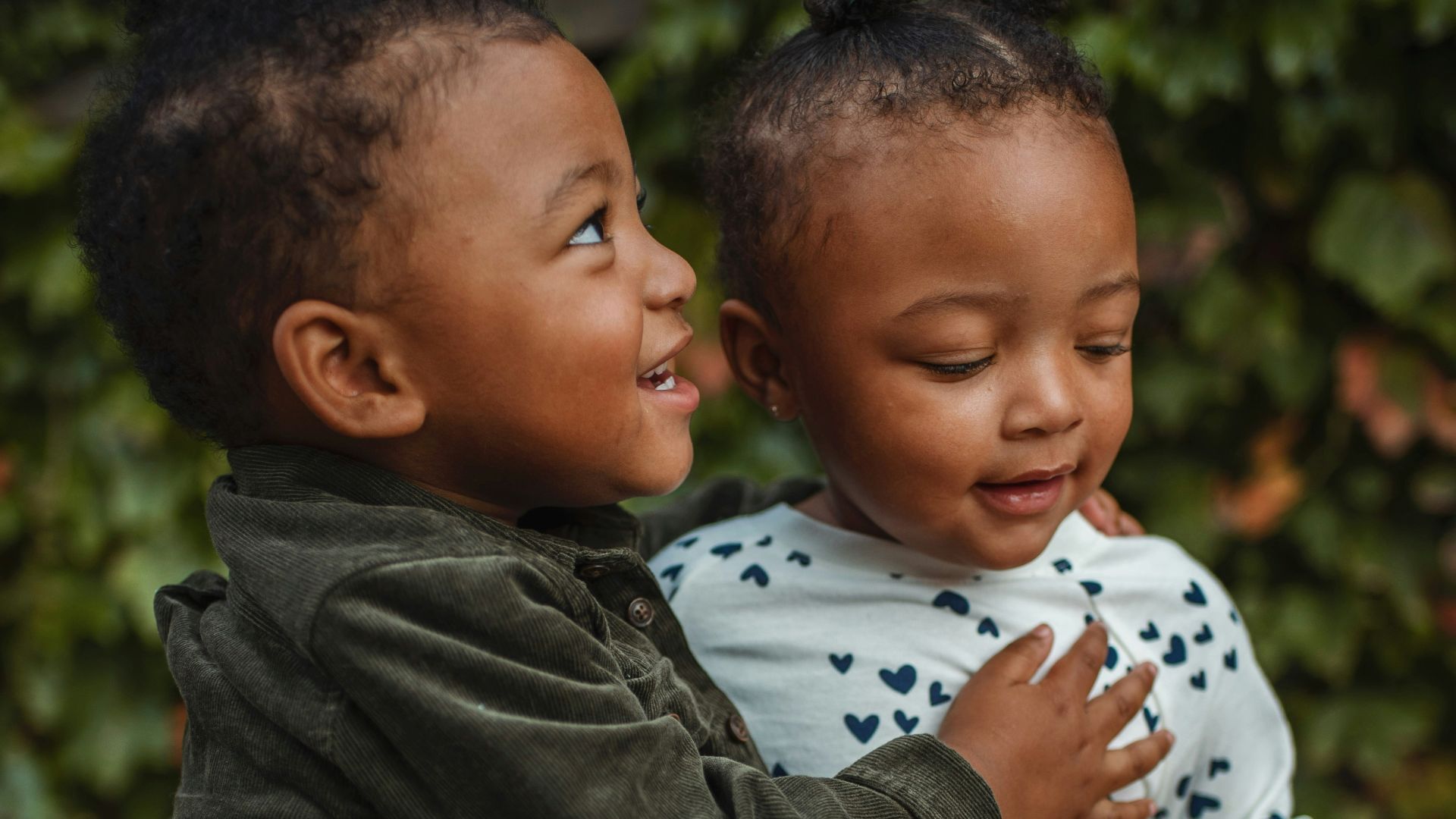 boy and girl surrounded by plants