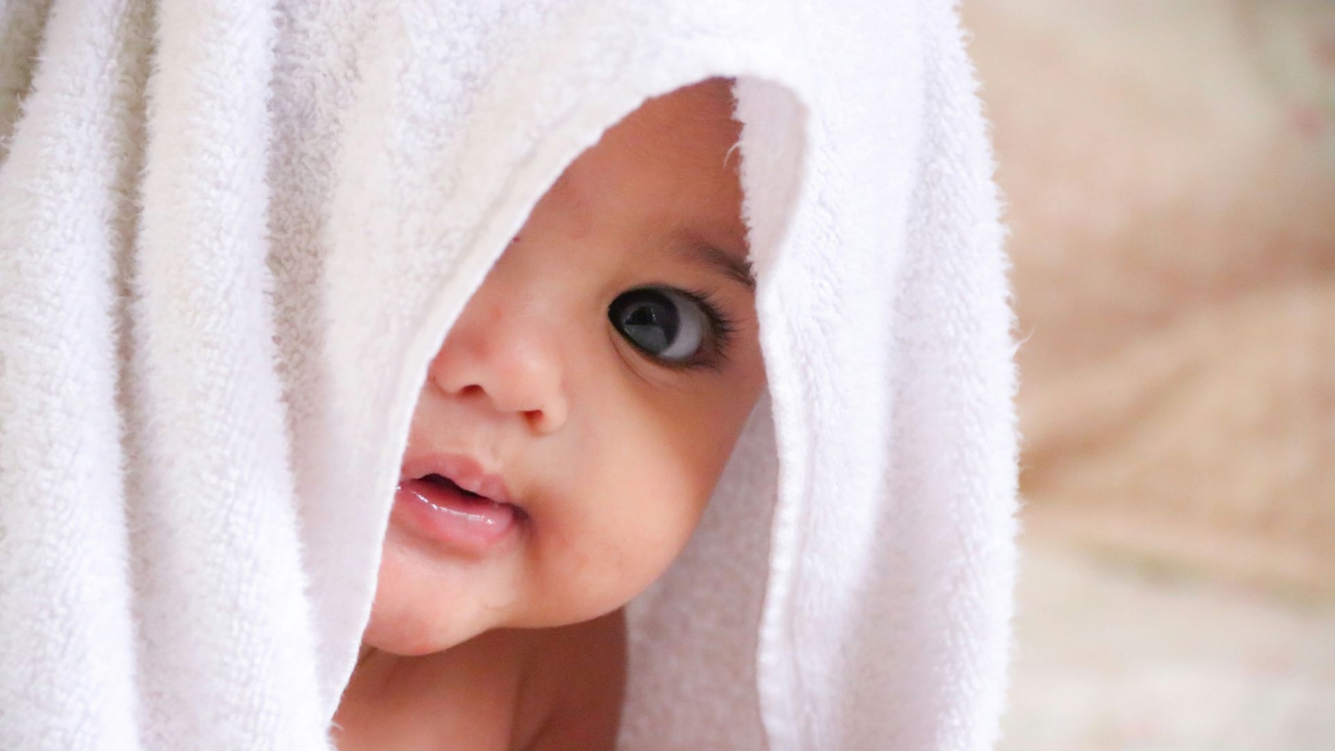 baby doll covered with white towel