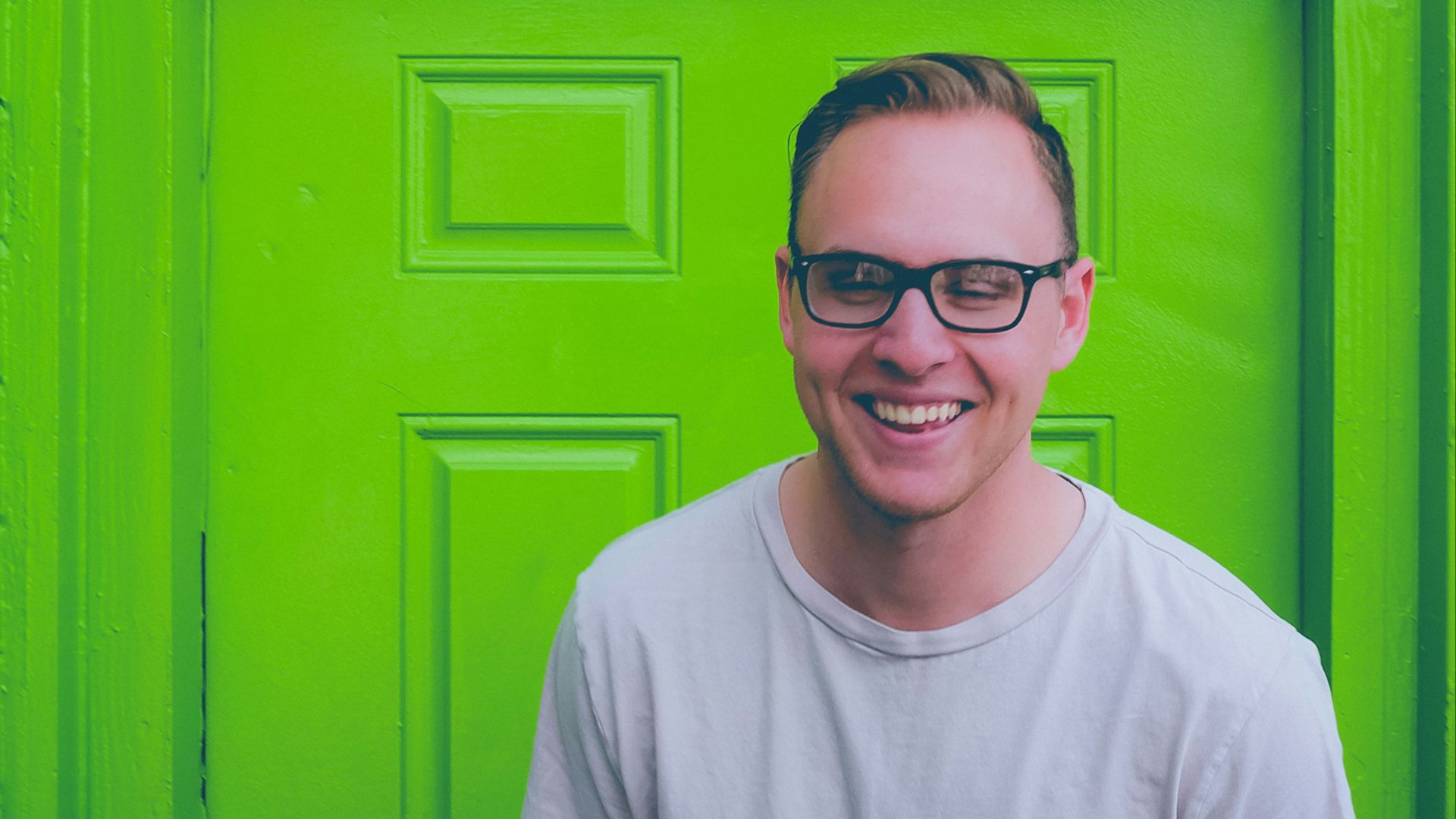 unknown person in white crew-neck top standing near green door