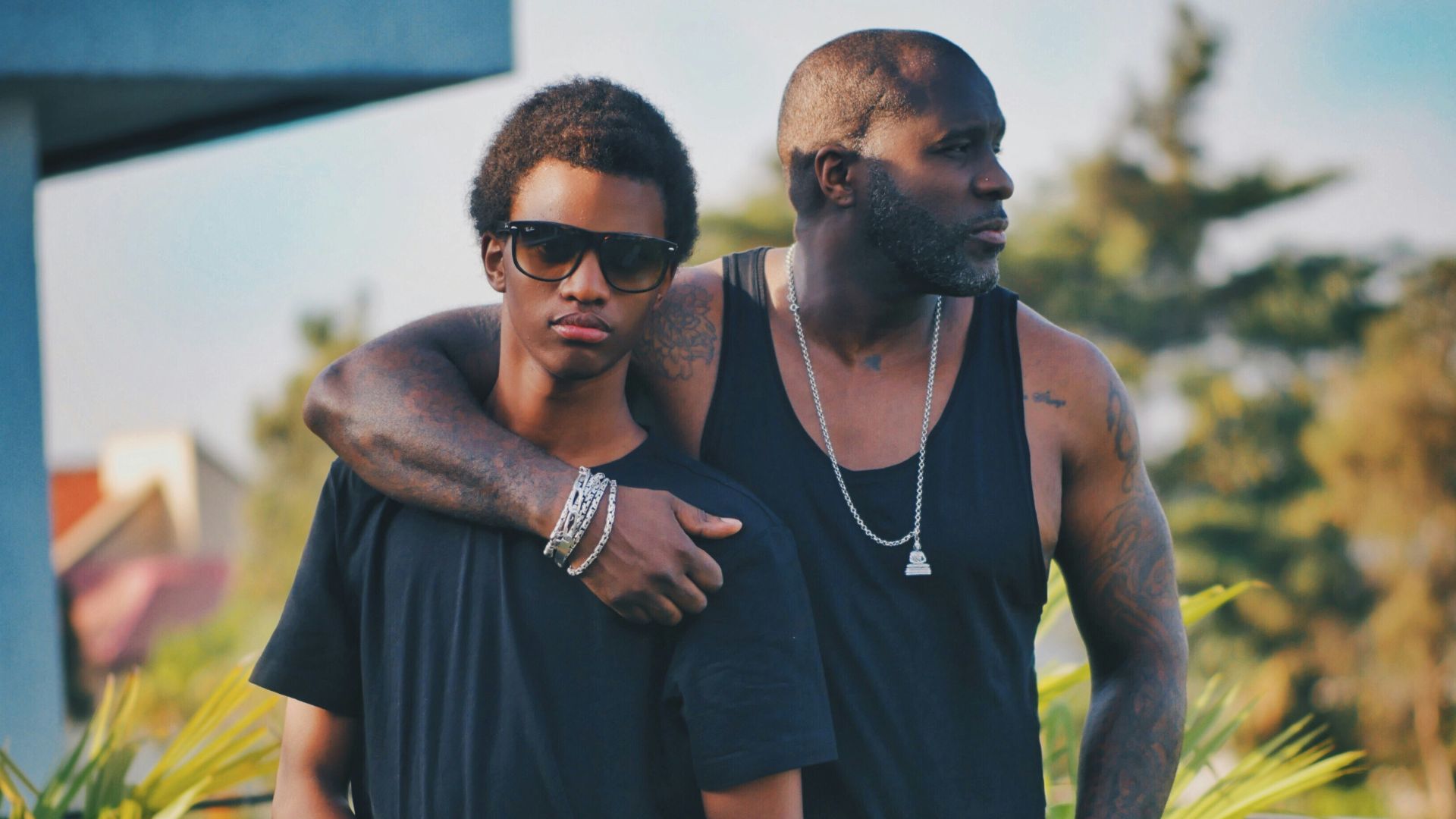 two men same standing near green leaf plant