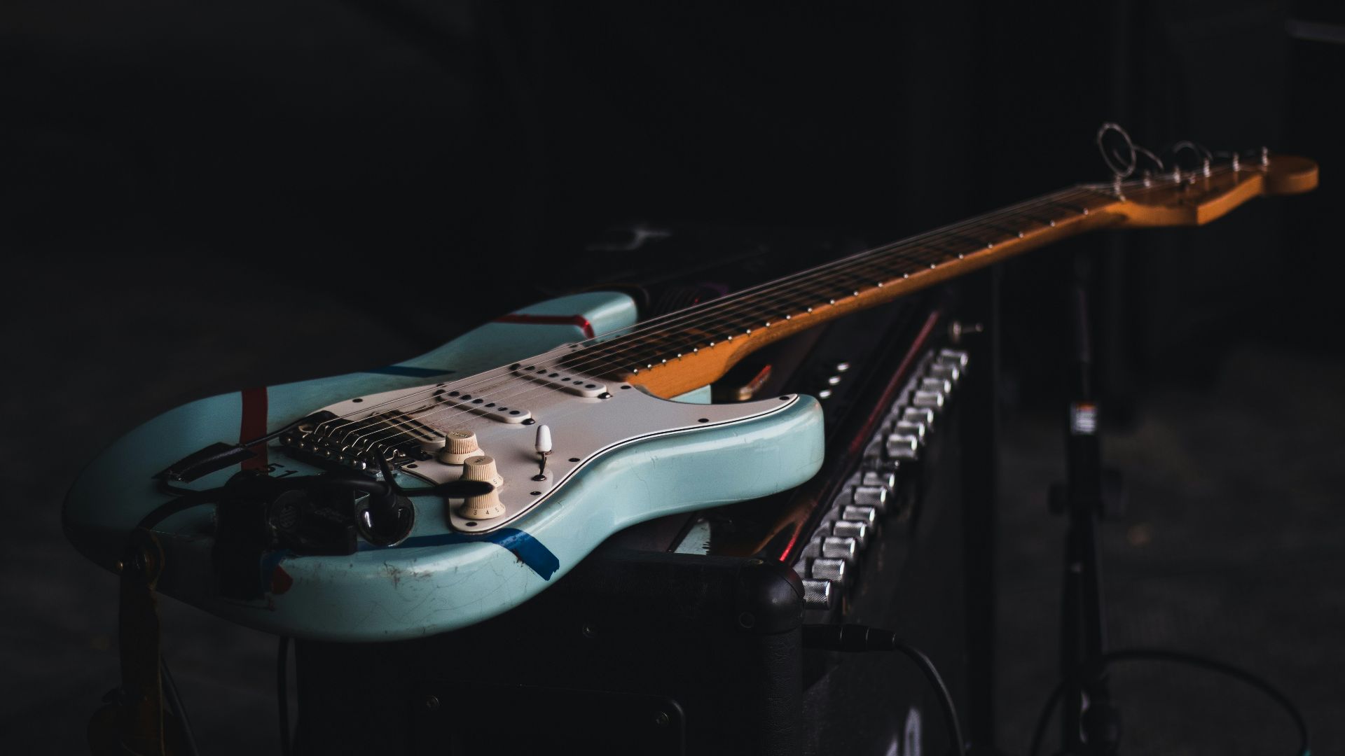 teal and brown electric guitar