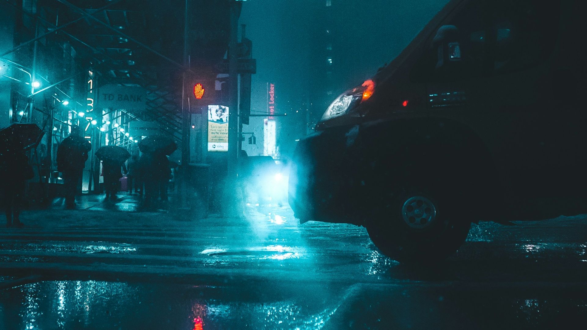vehicle passing by wet road during nighttime
