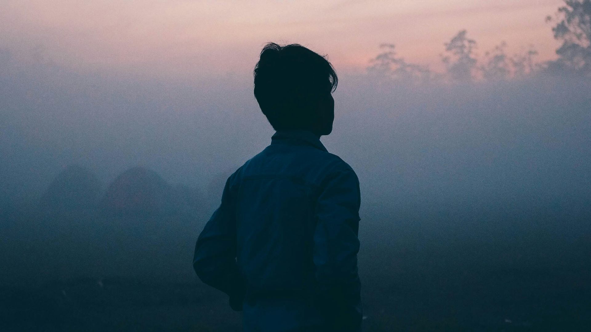 a man walks alone in the haze