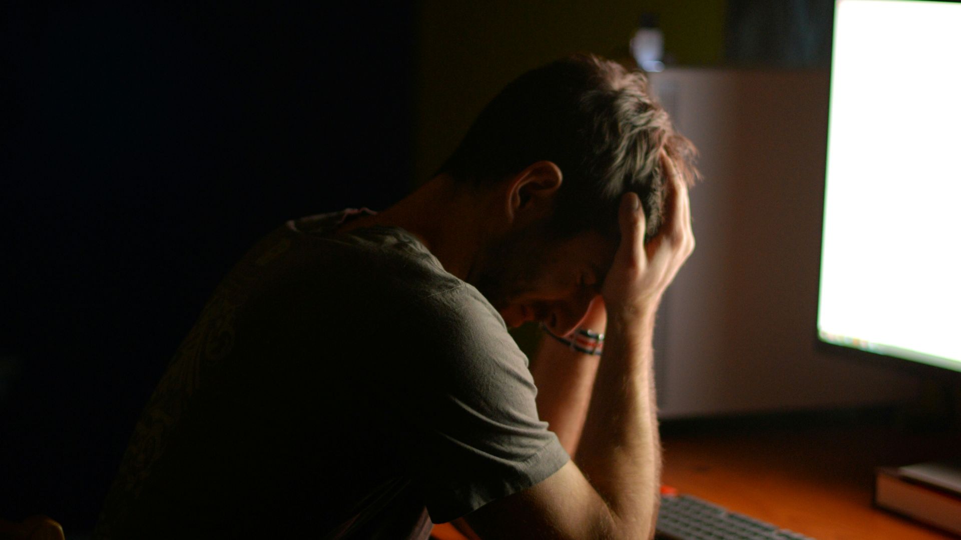 a man sitting at a desk in front of a computer