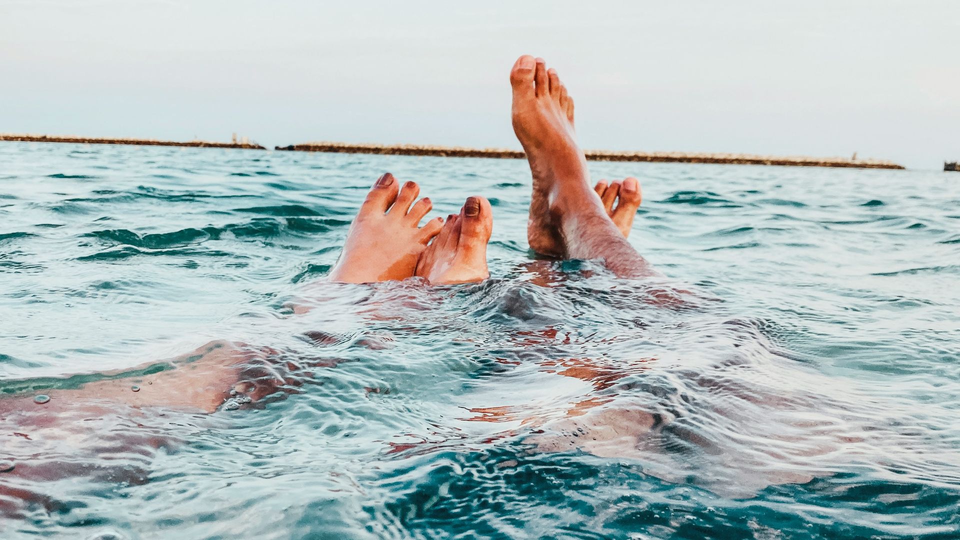 a person's feet in the water