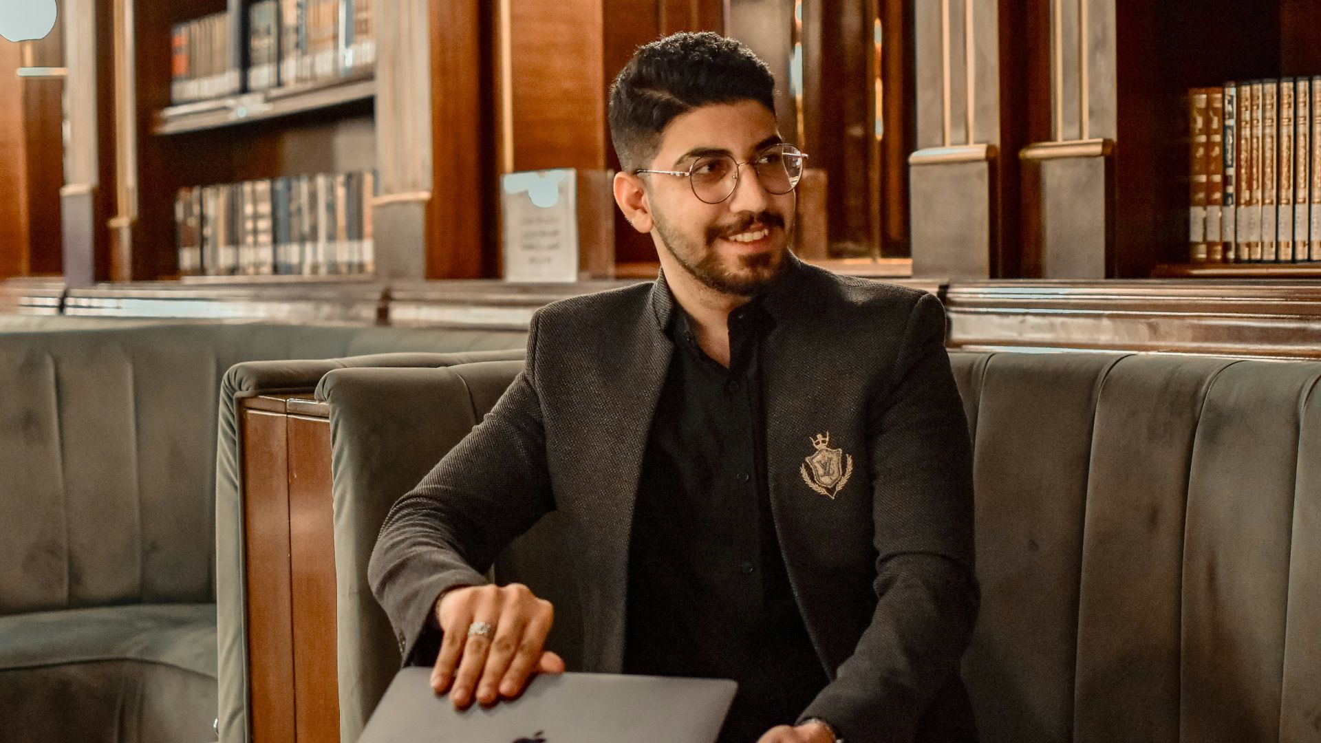 a man sitting at a table with a laptop