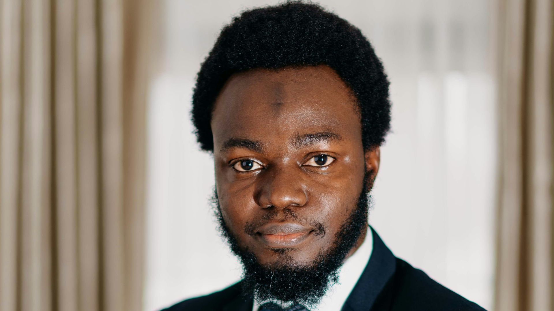 a man in a suit and tie posing for a picture