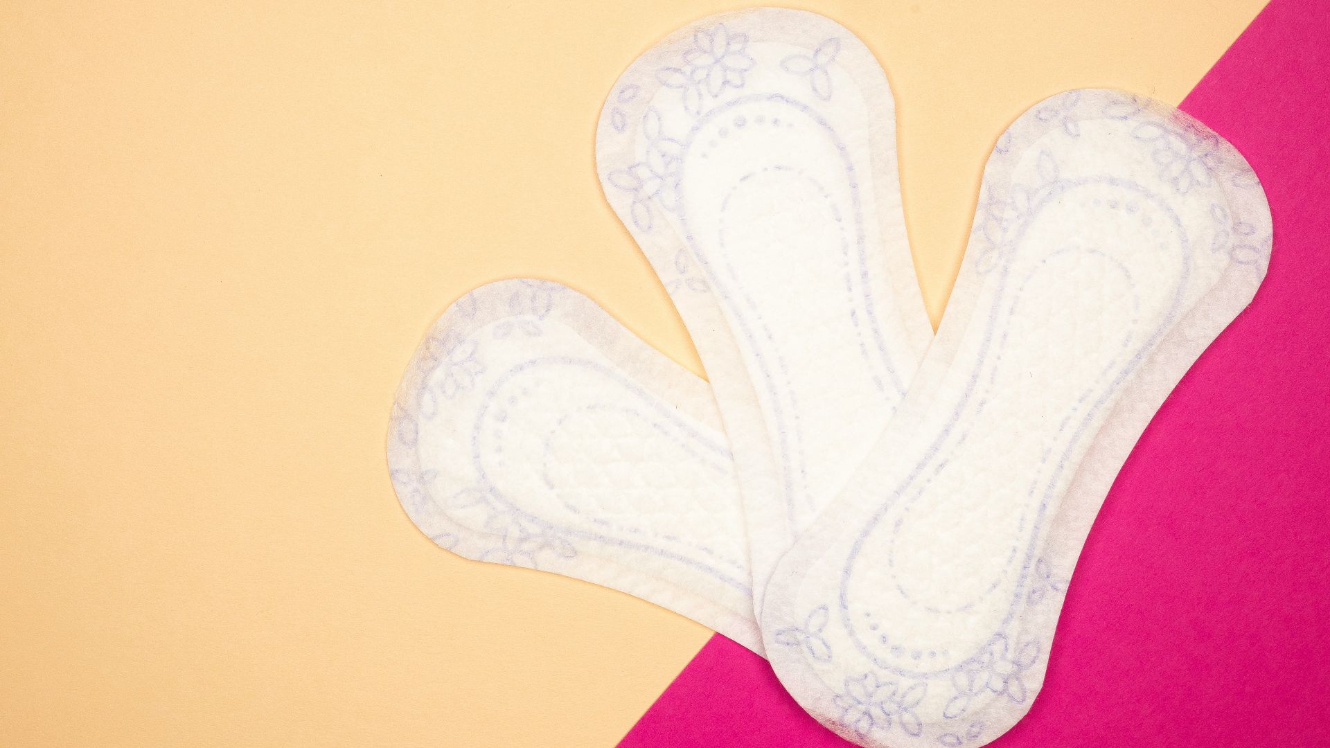 a pair of white socks sitting on top of a pink and yellow table