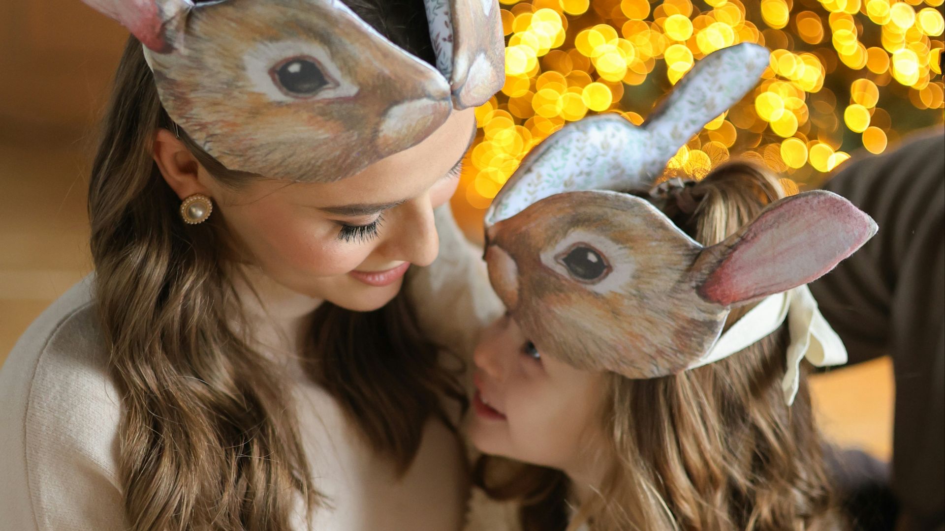 A woman and a child wearing bunny ears