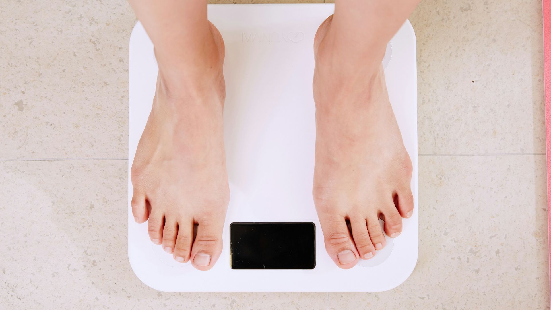 person standing on white digital bathroom scale