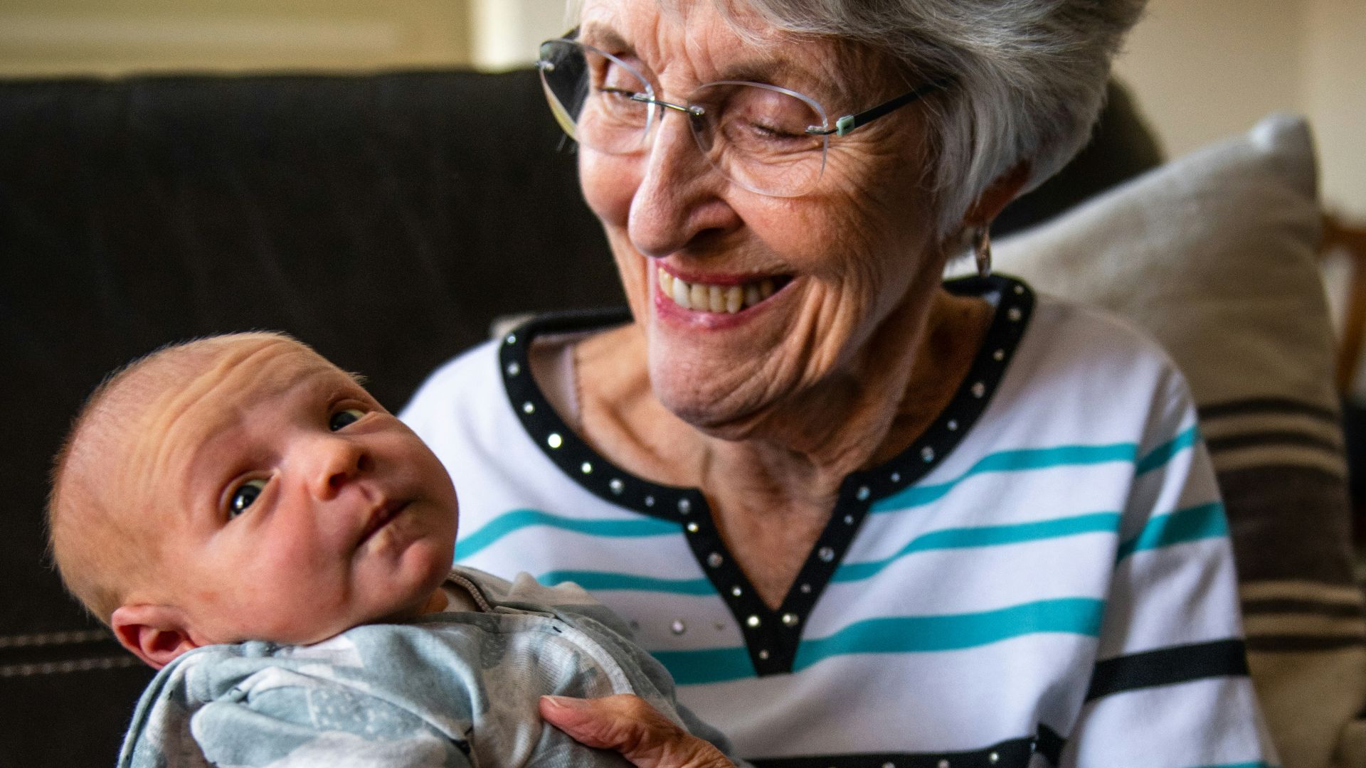 an older woman holding a baby