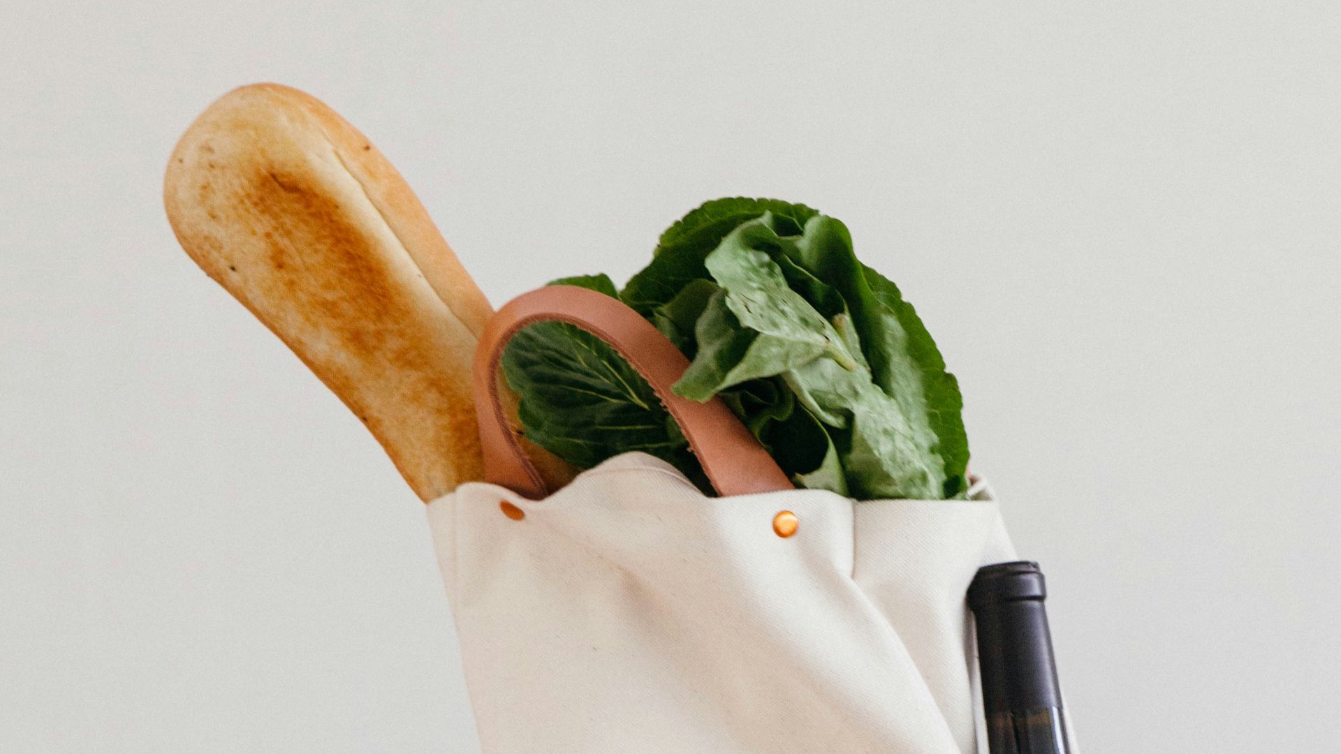 brown wooden rolling pin beside white paper bag