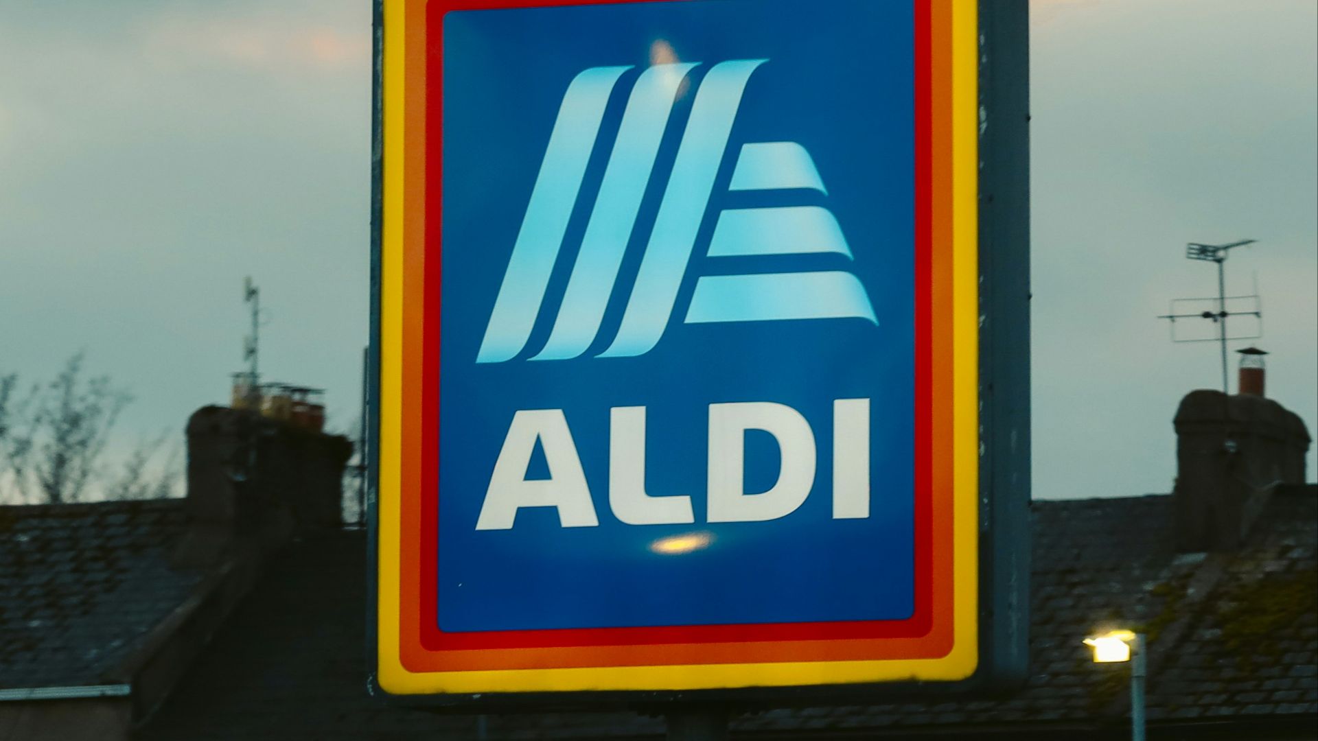 a blue and yellow aldi sign in front of a building