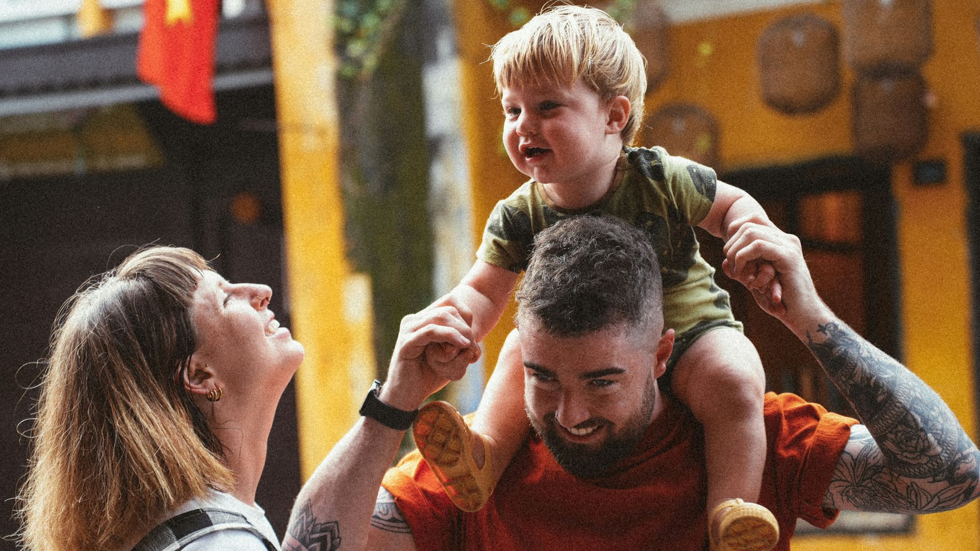 a man holding a young boy on his shoulders