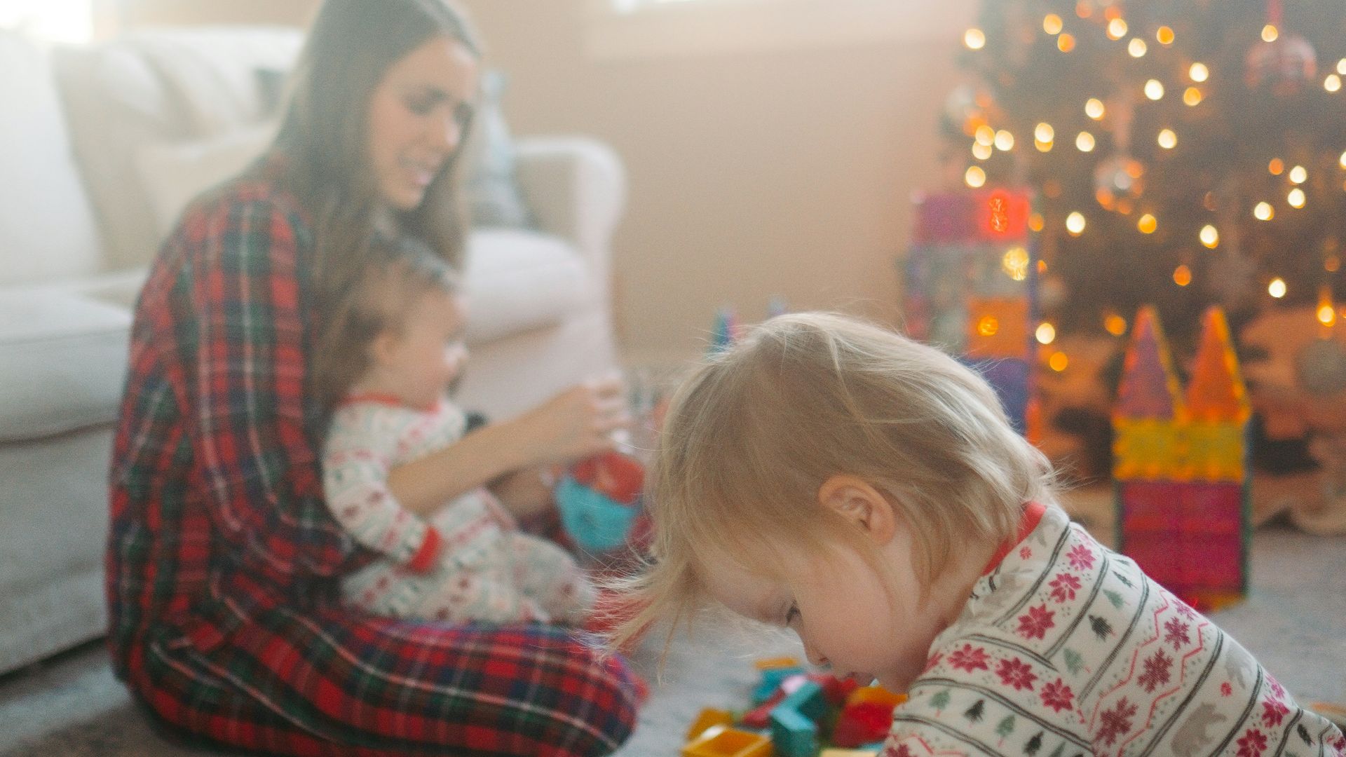 a woman and a baby playing with toys