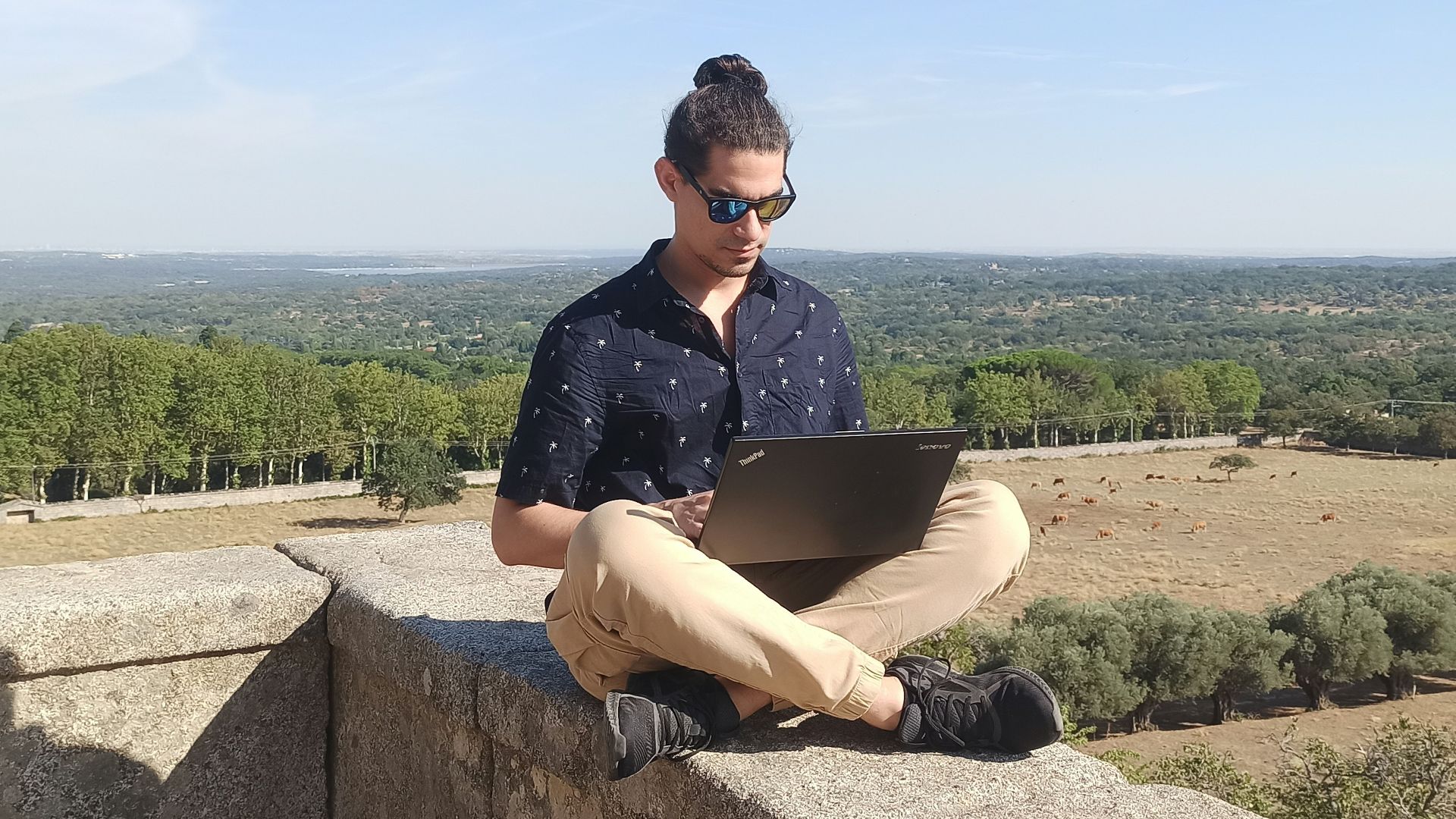 woman in black shirt sitting on gray concrete bench during daytime