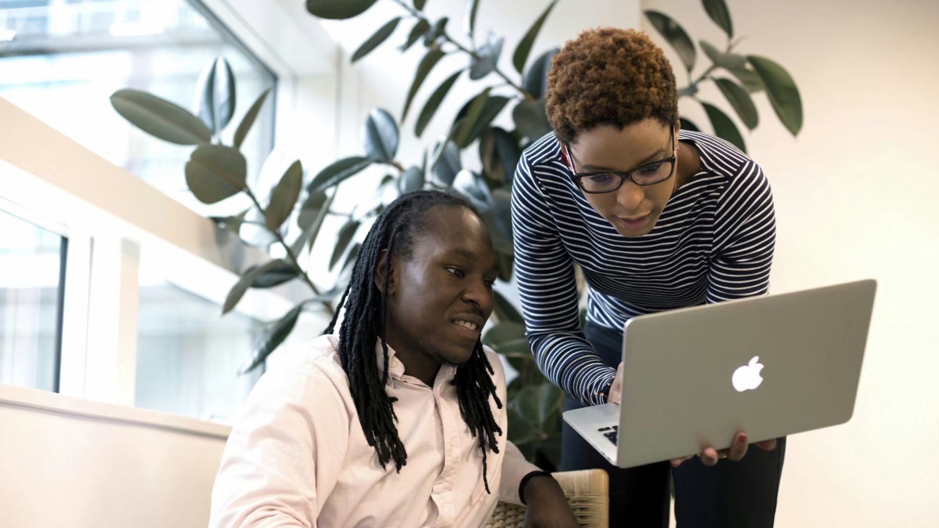 two women looking at a laptop computer screen