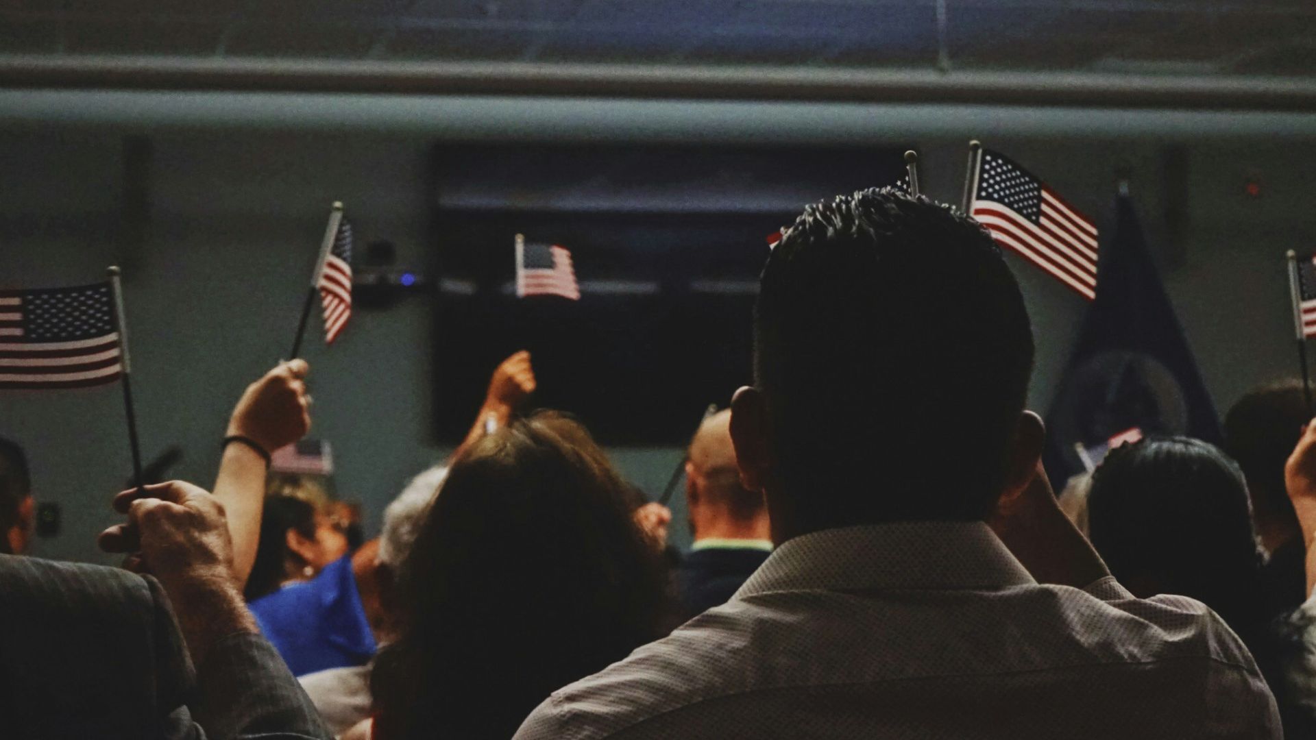 people holding flag of U.S.A miniature