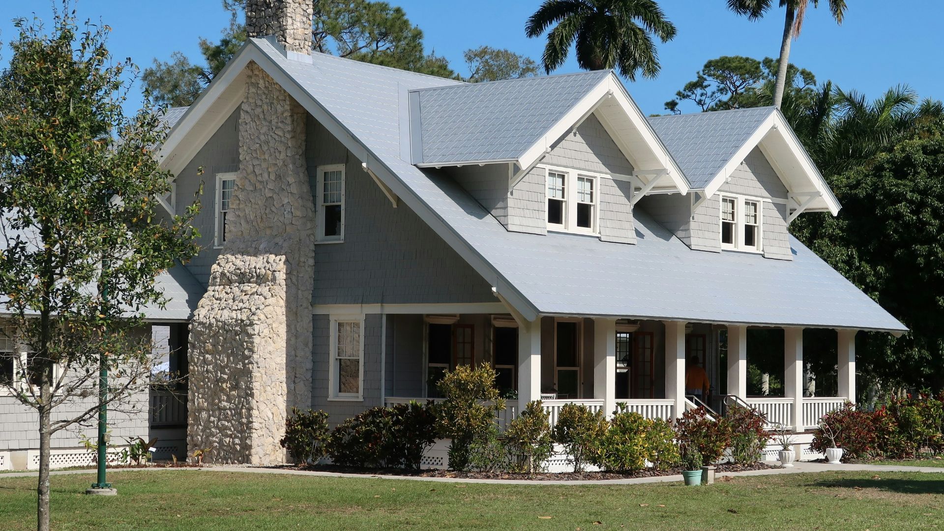 brown and white concrete house near green grass field during daytime