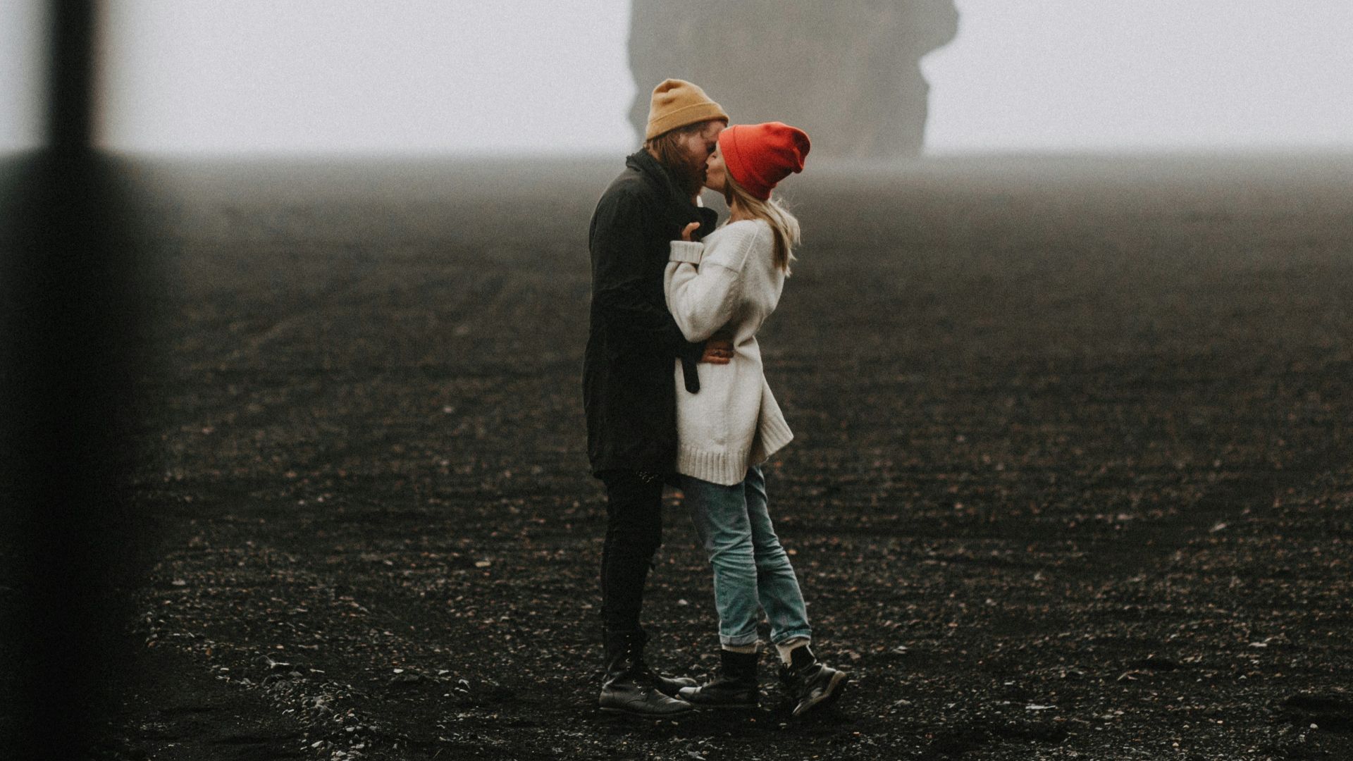 a man and a woman standing in a field