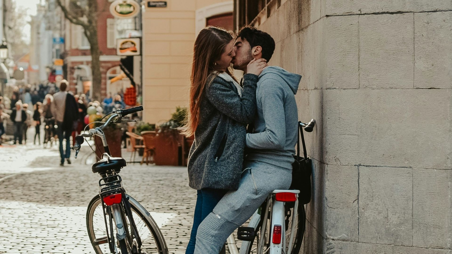 woman in blue denim jacket and blue denim jeans riding on black bicycle during daytime