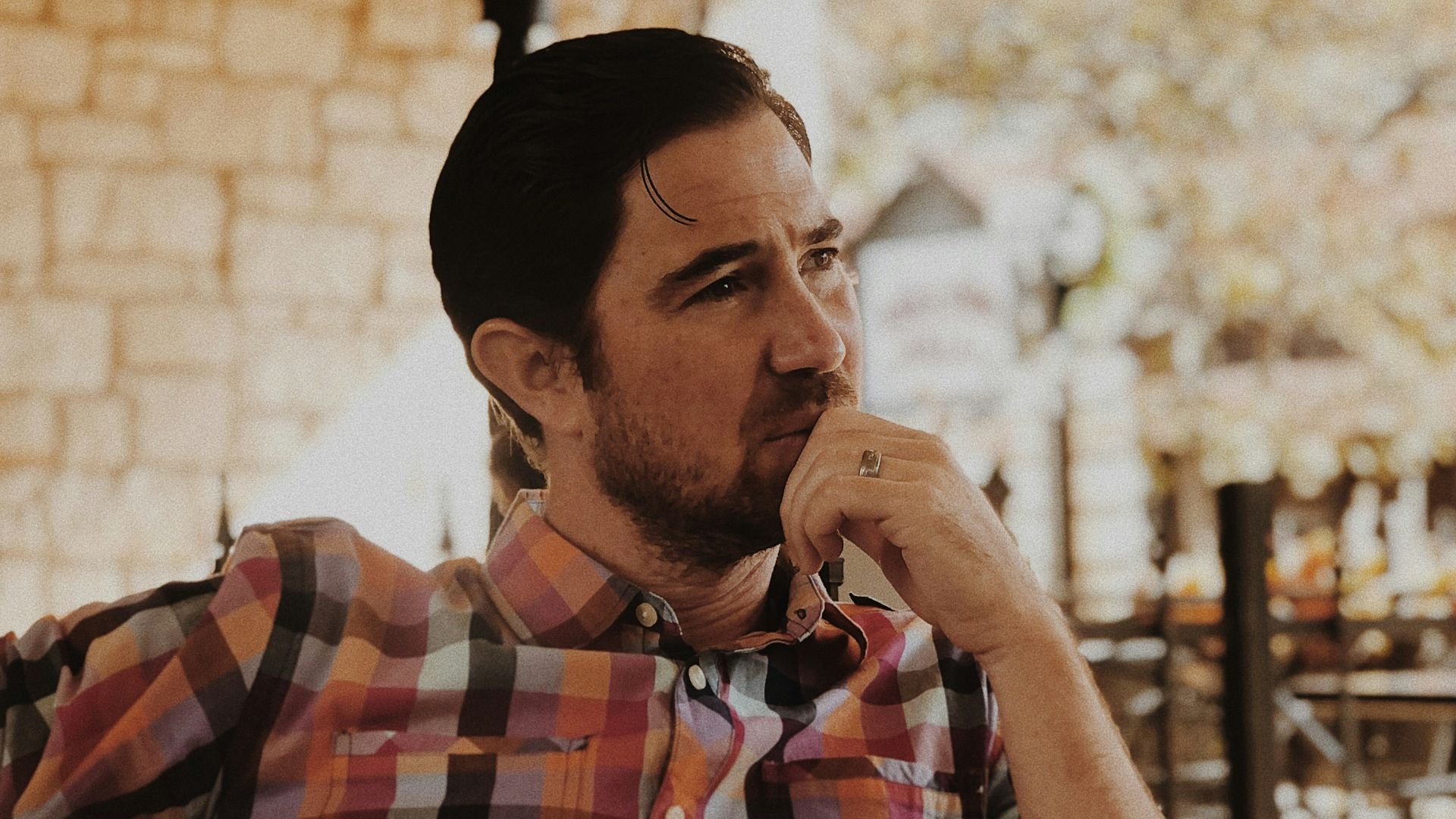 man in red and black plaid dress shirt