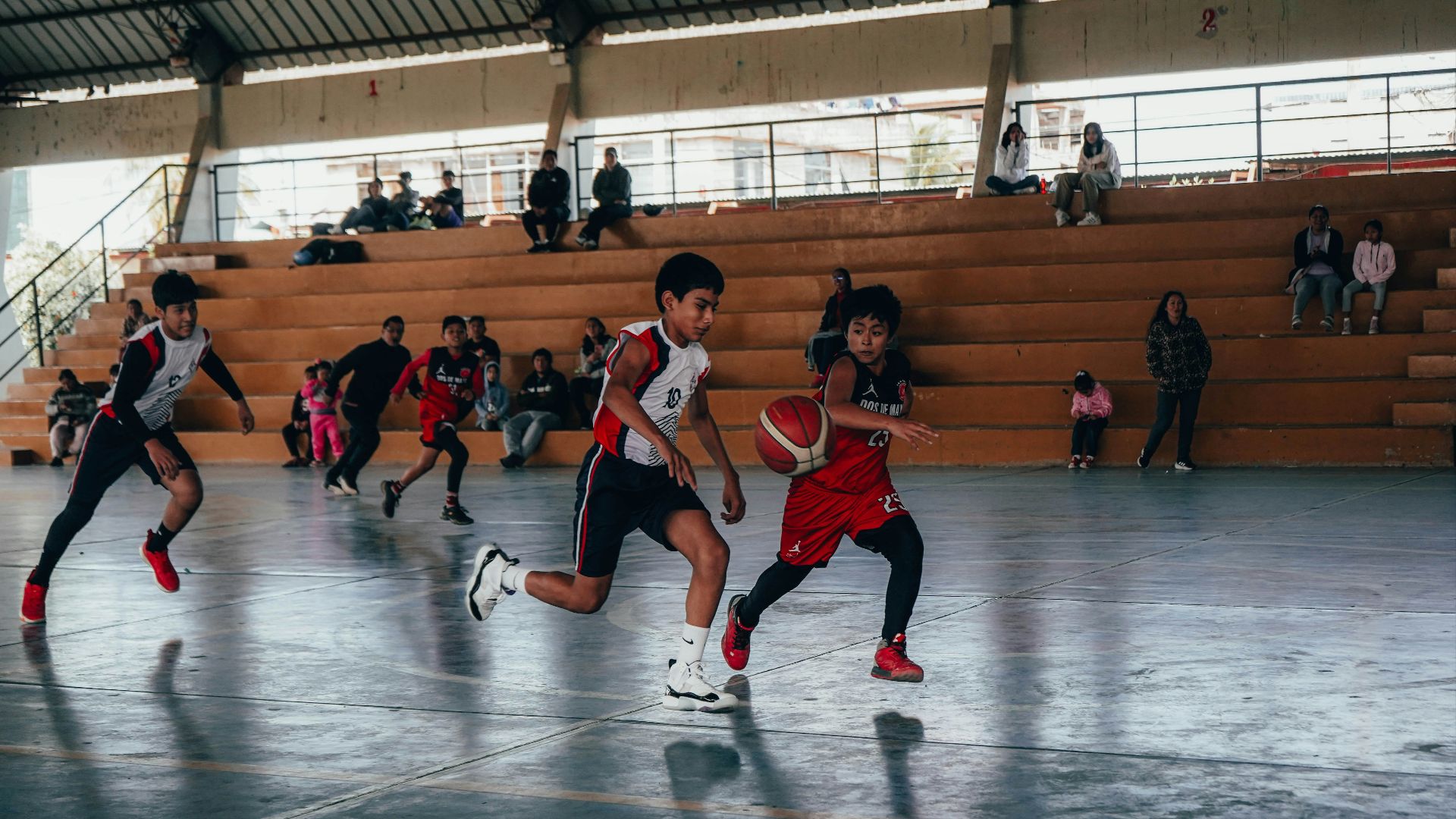 A group of young men playing a game of basketball