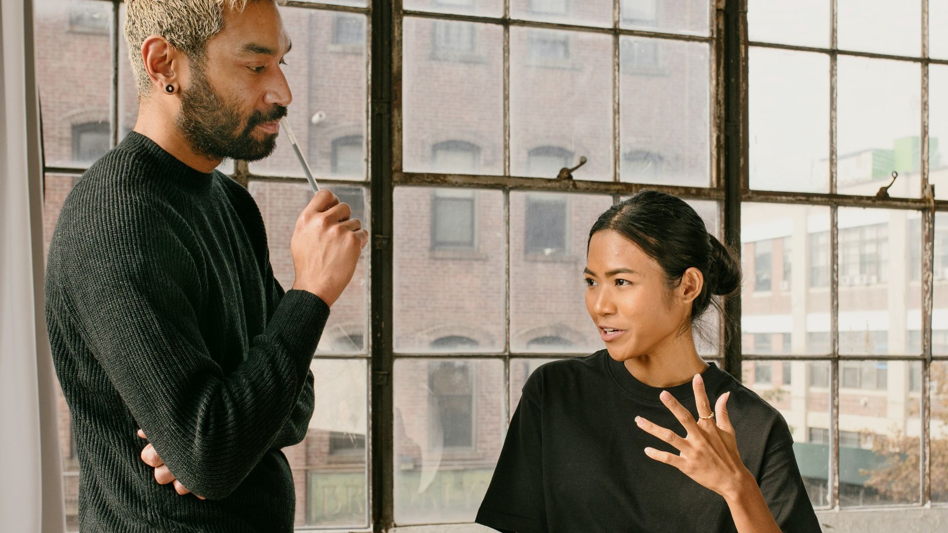 a man standing next to a woman at a table