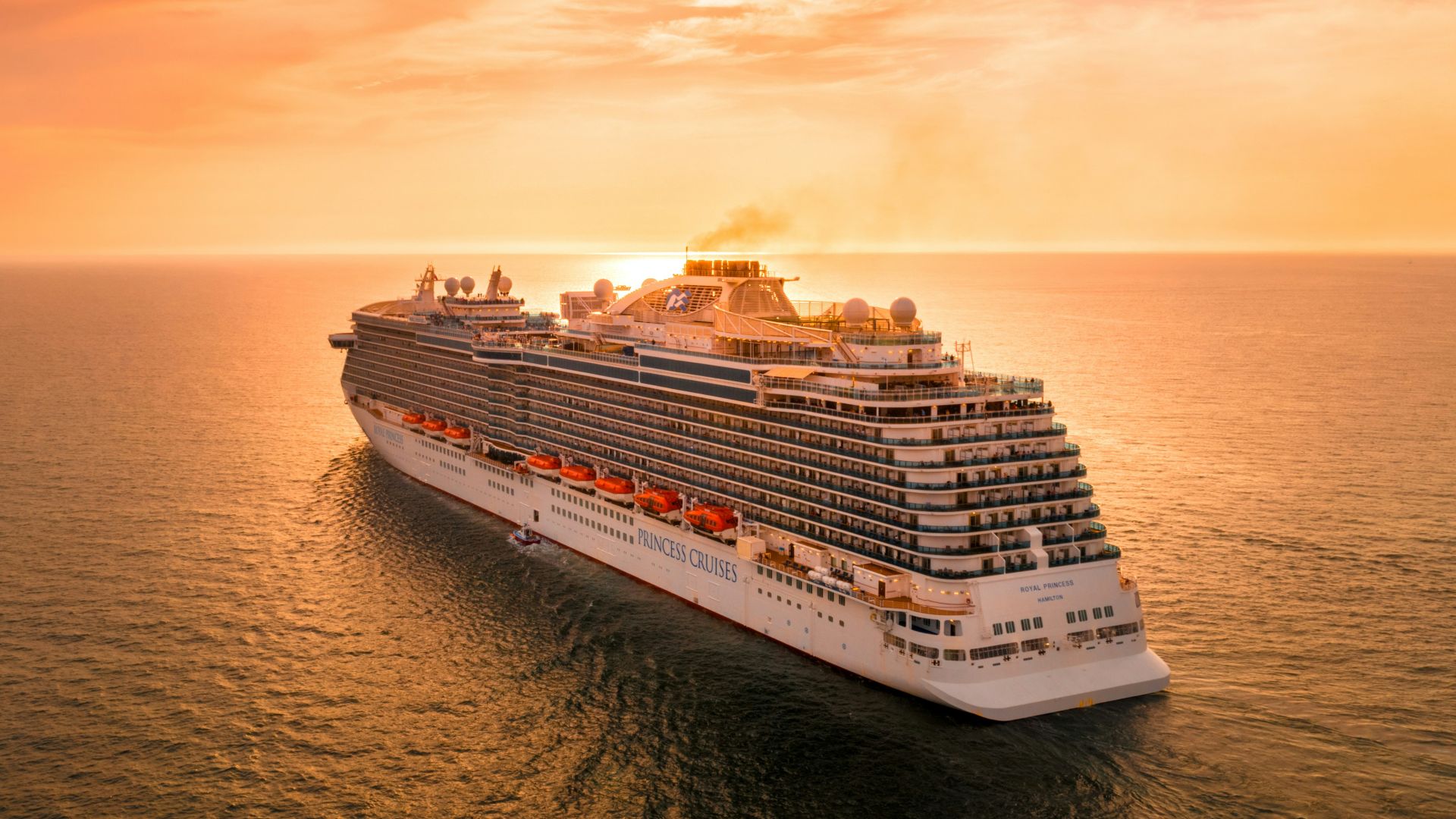 white ship on sea during sunset