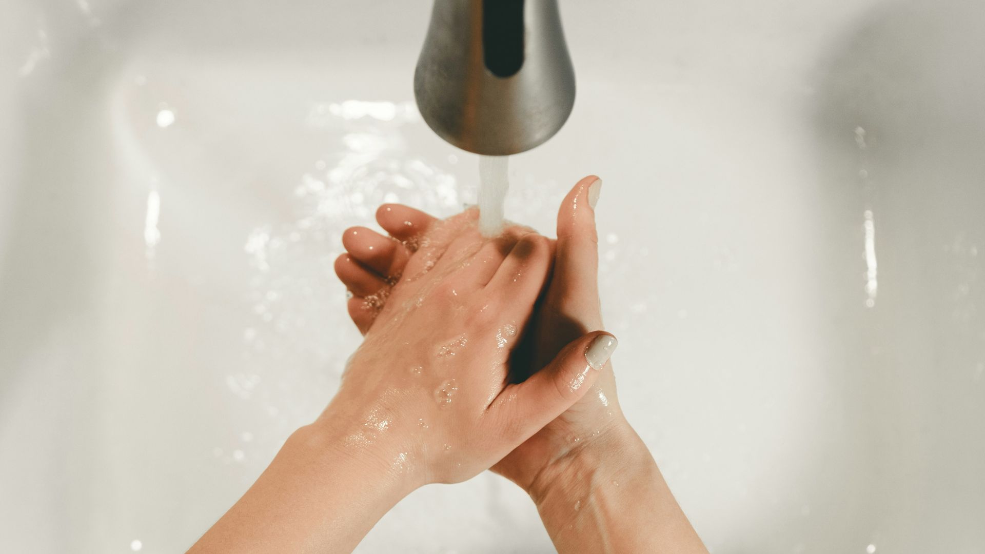 persons feet on white bathtub