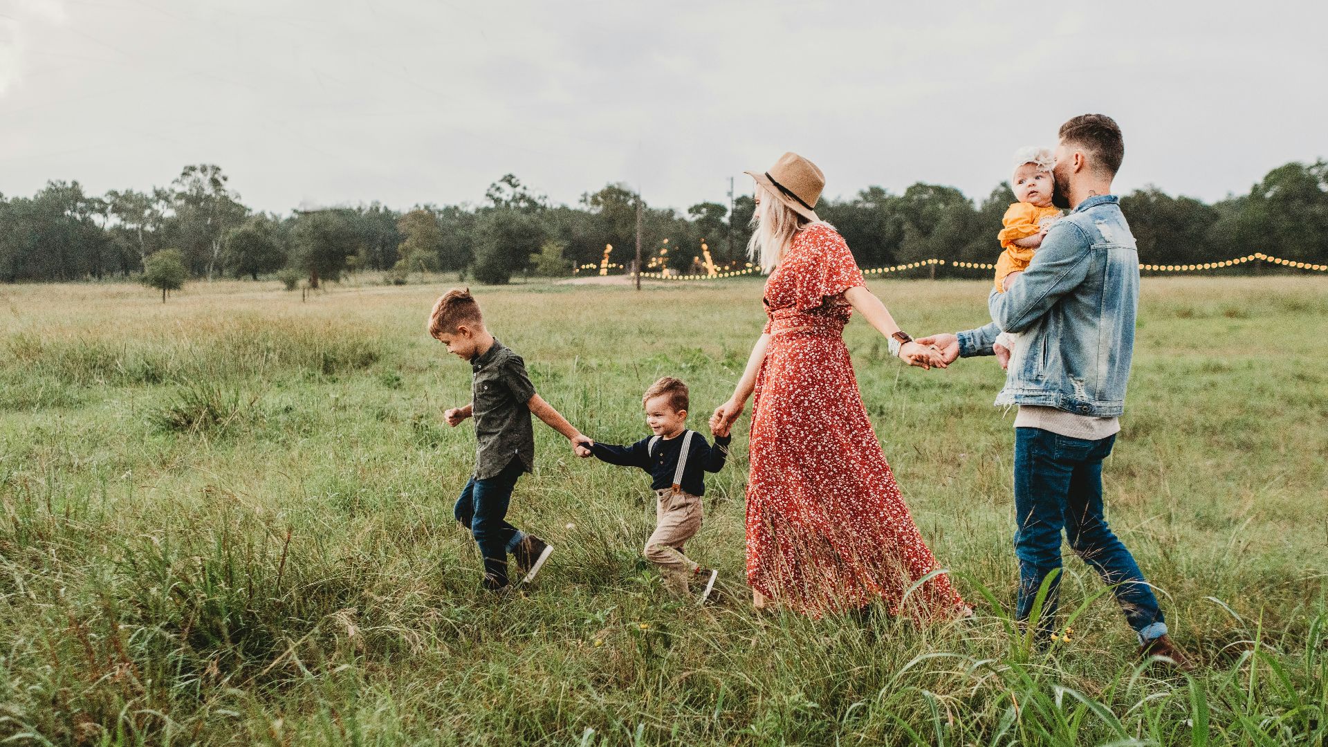 woman holding man and toddler hands during daytime