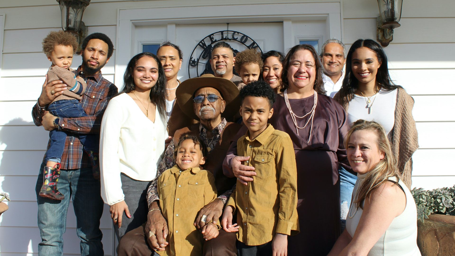 group of people standing near white building