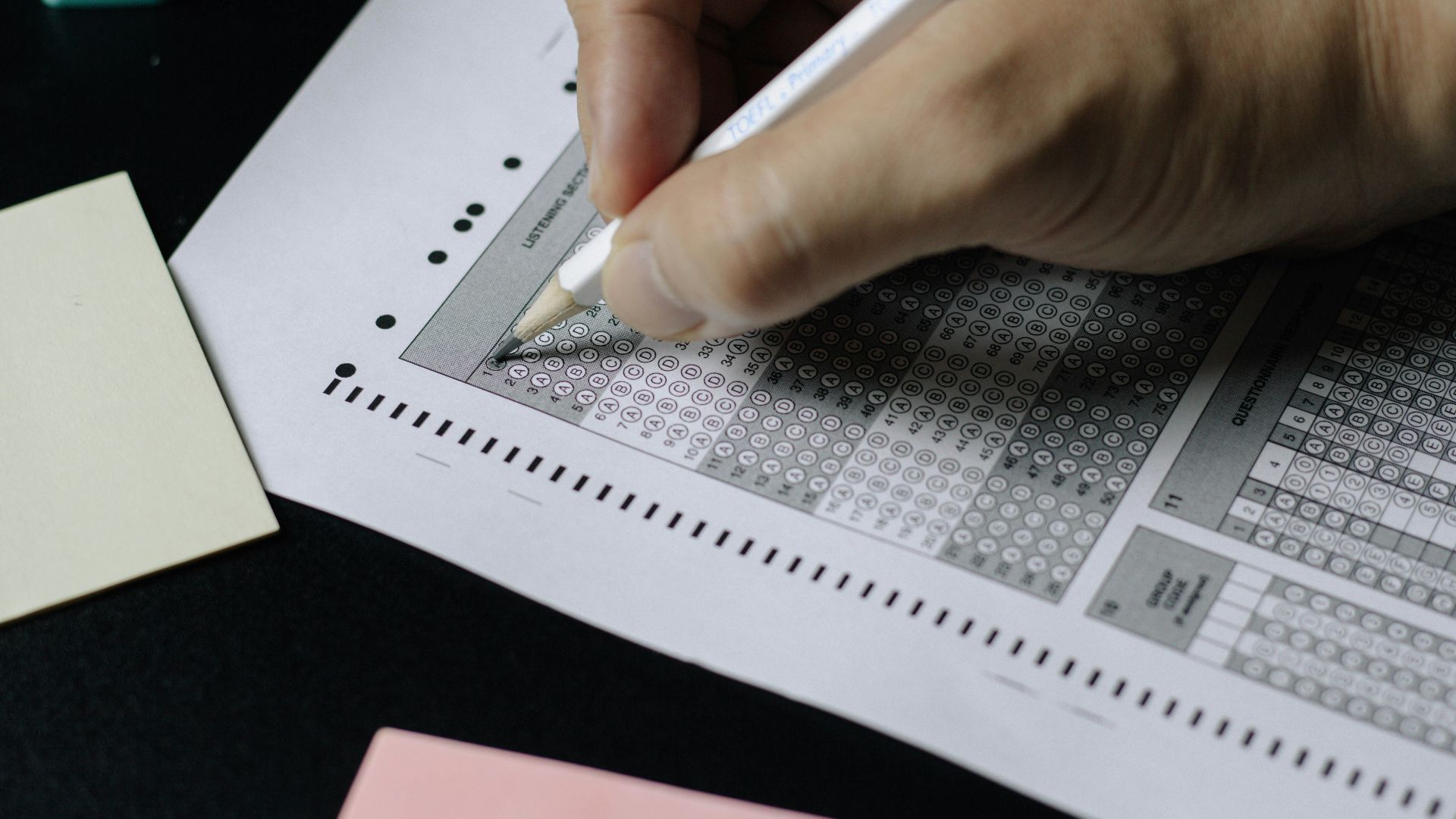 person writing on white paper