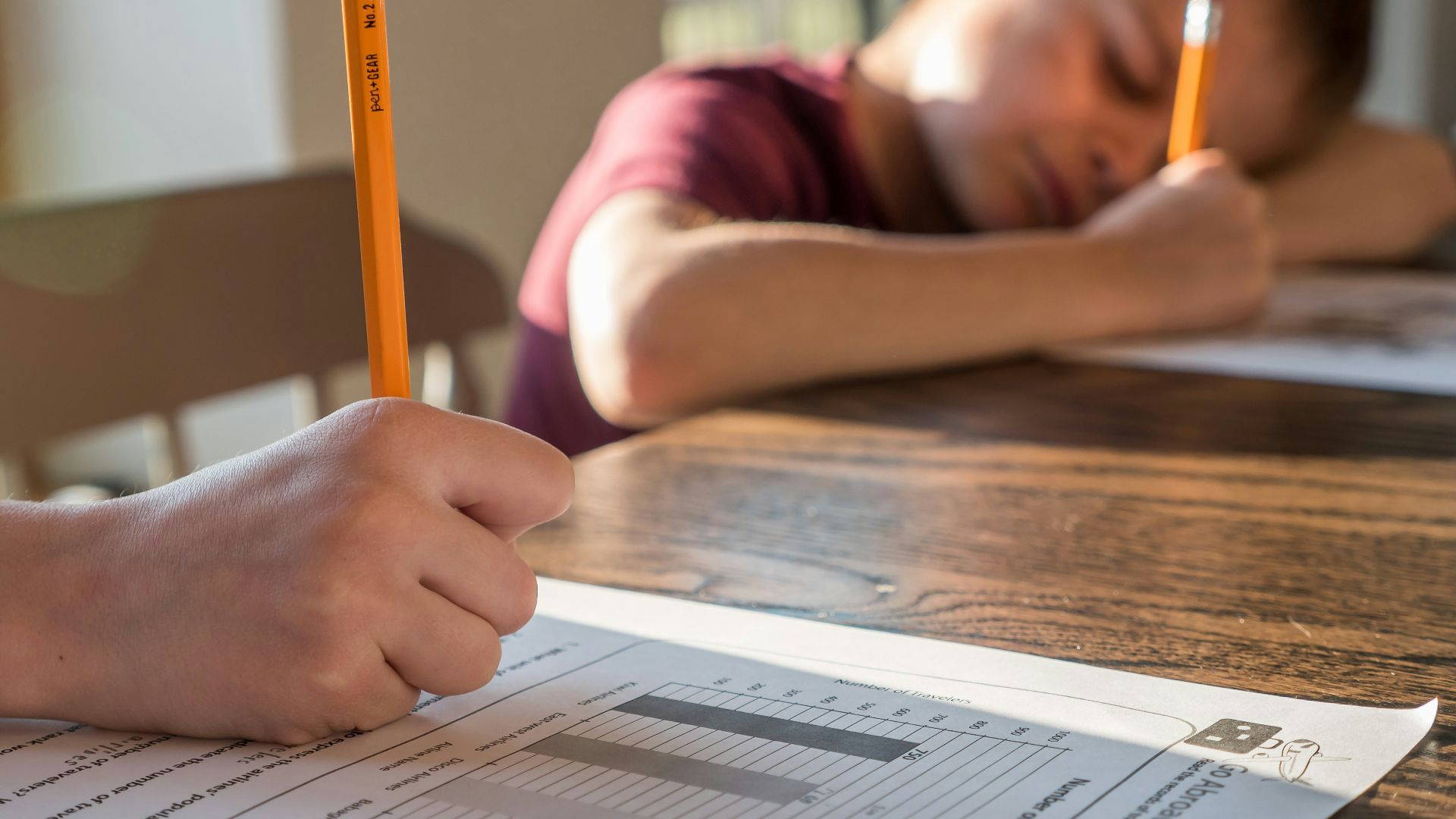 person writing on white paper