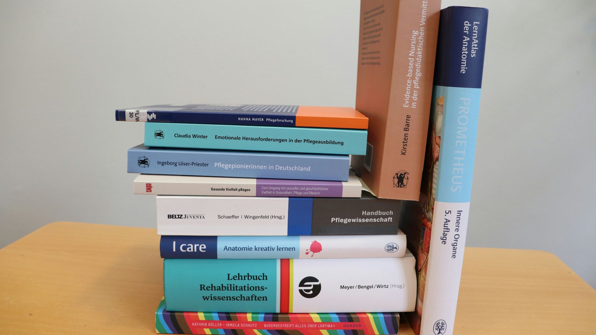 A stack of books sitting on top of a wooden table