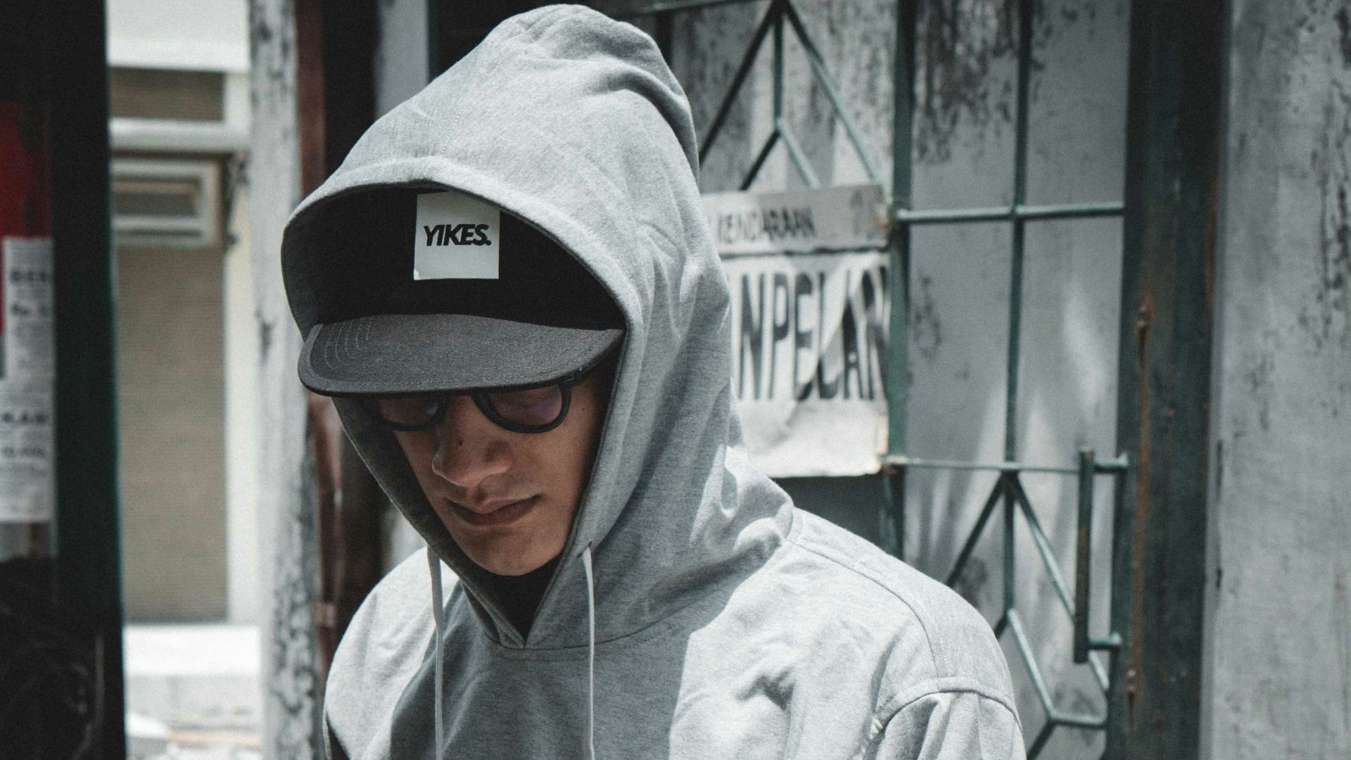 man standing near grey wlal