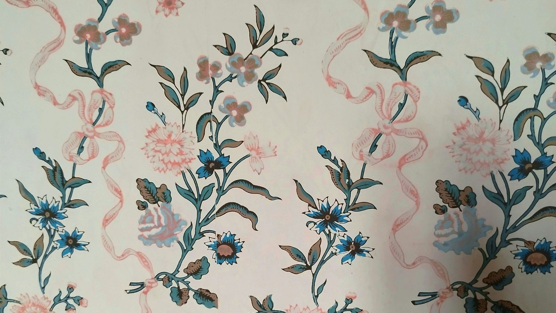a floral wallpaper with blue and pink flowers