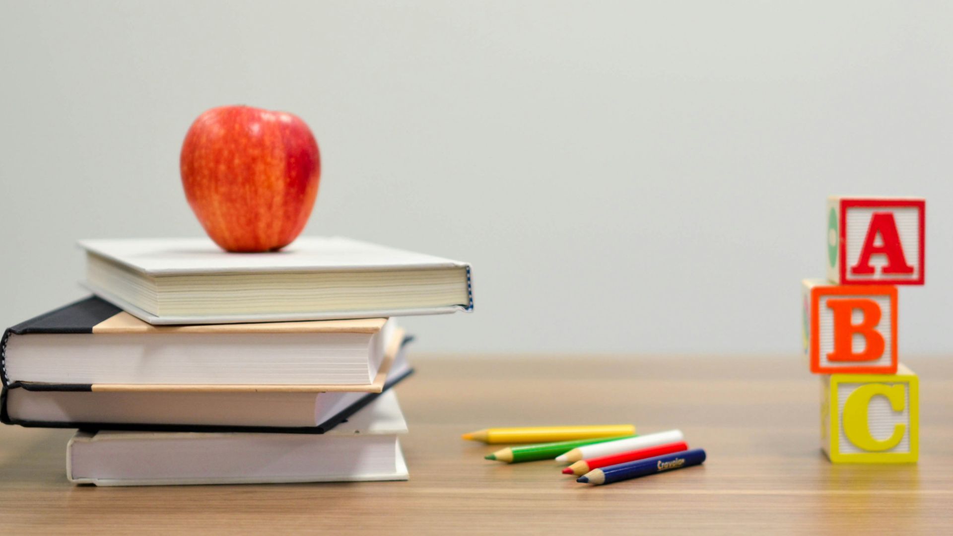 red apple fruit on four pyle books