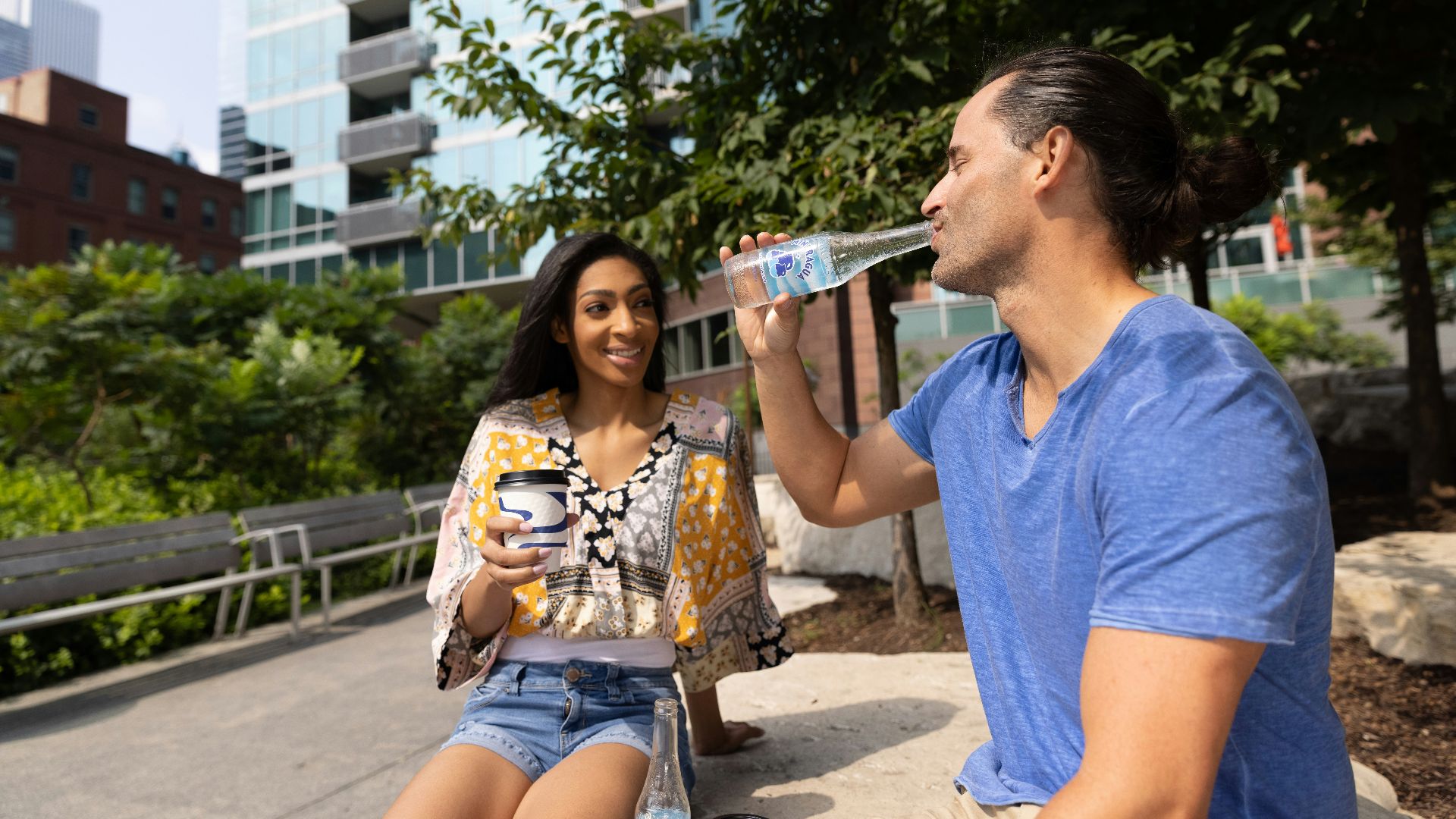 woman in blue crew neck t-shirt drinking from clear drinking glass